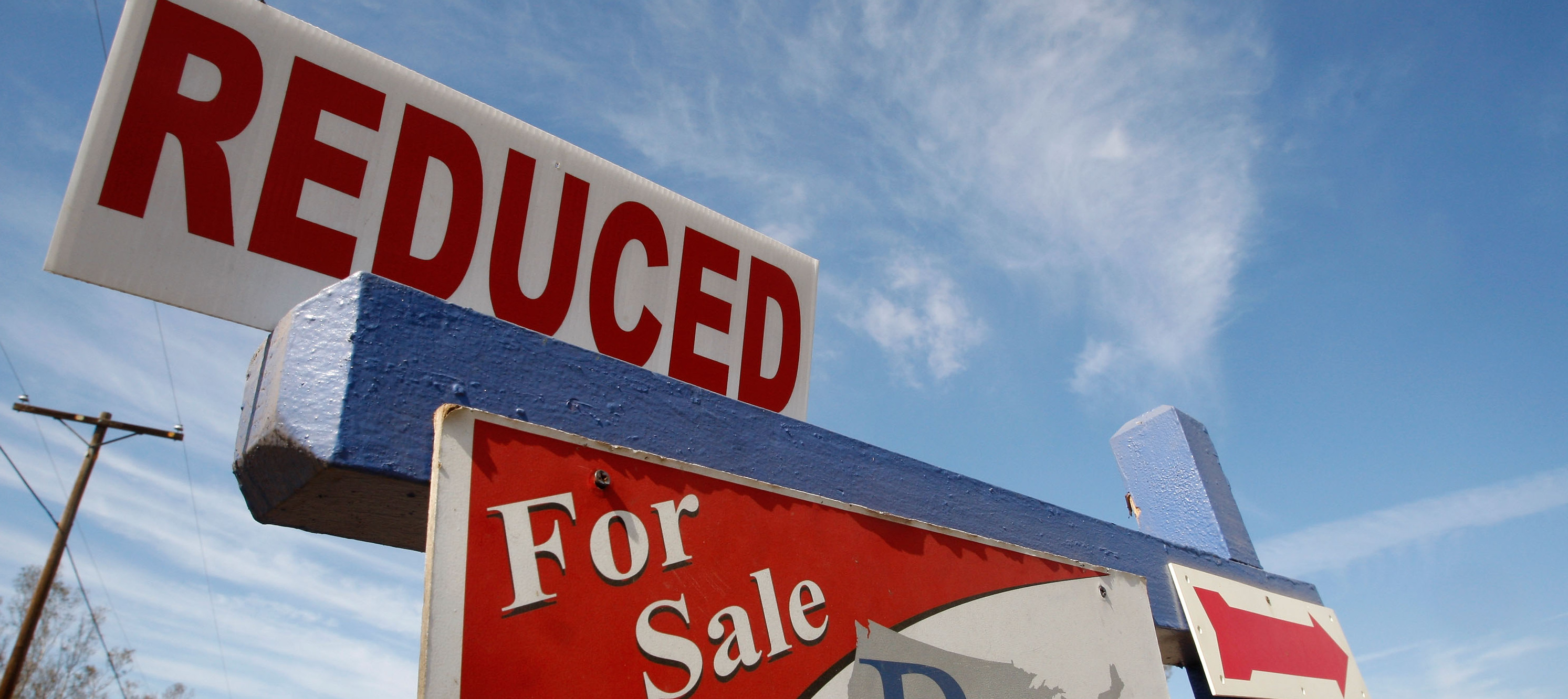A for sale sign indicates that a property's price tag has been reduced.