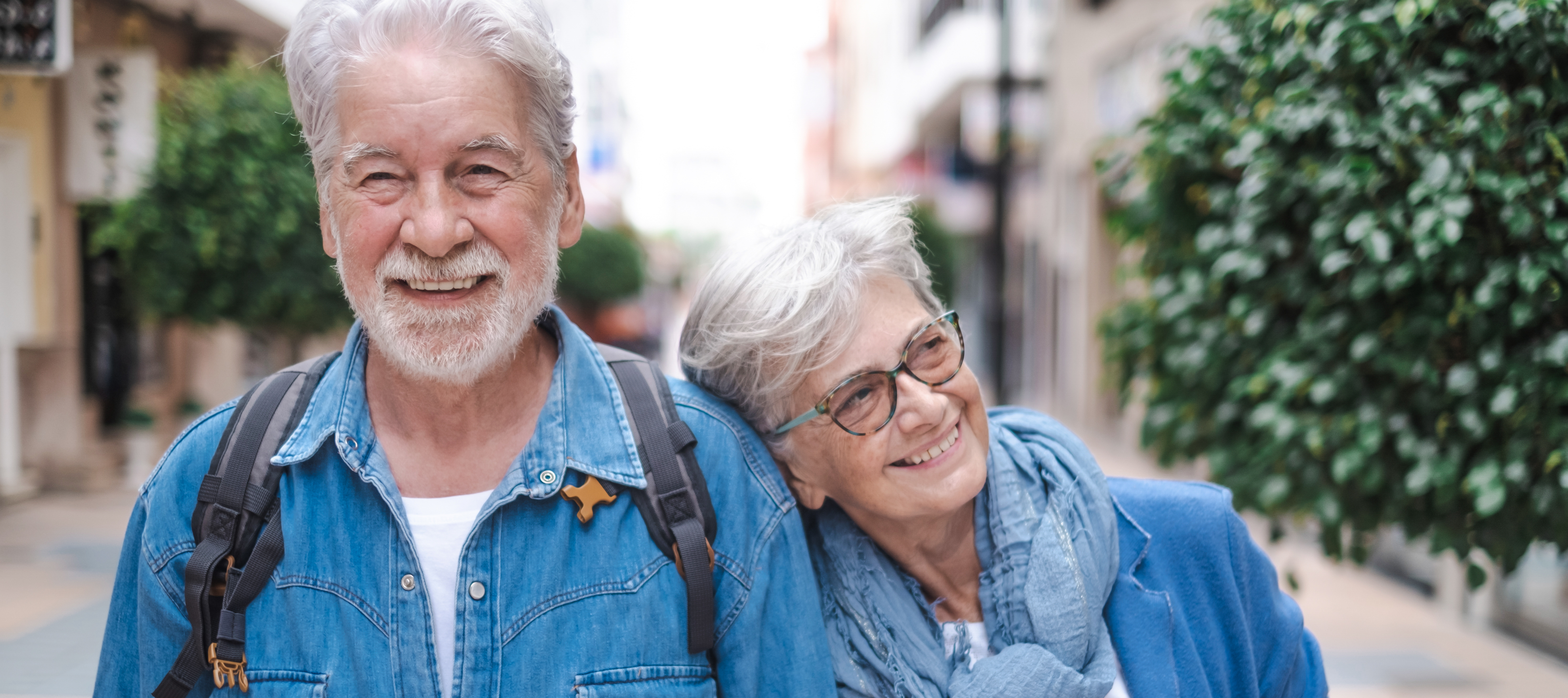 A retired couple enjoying their peace of mind while on a walk.