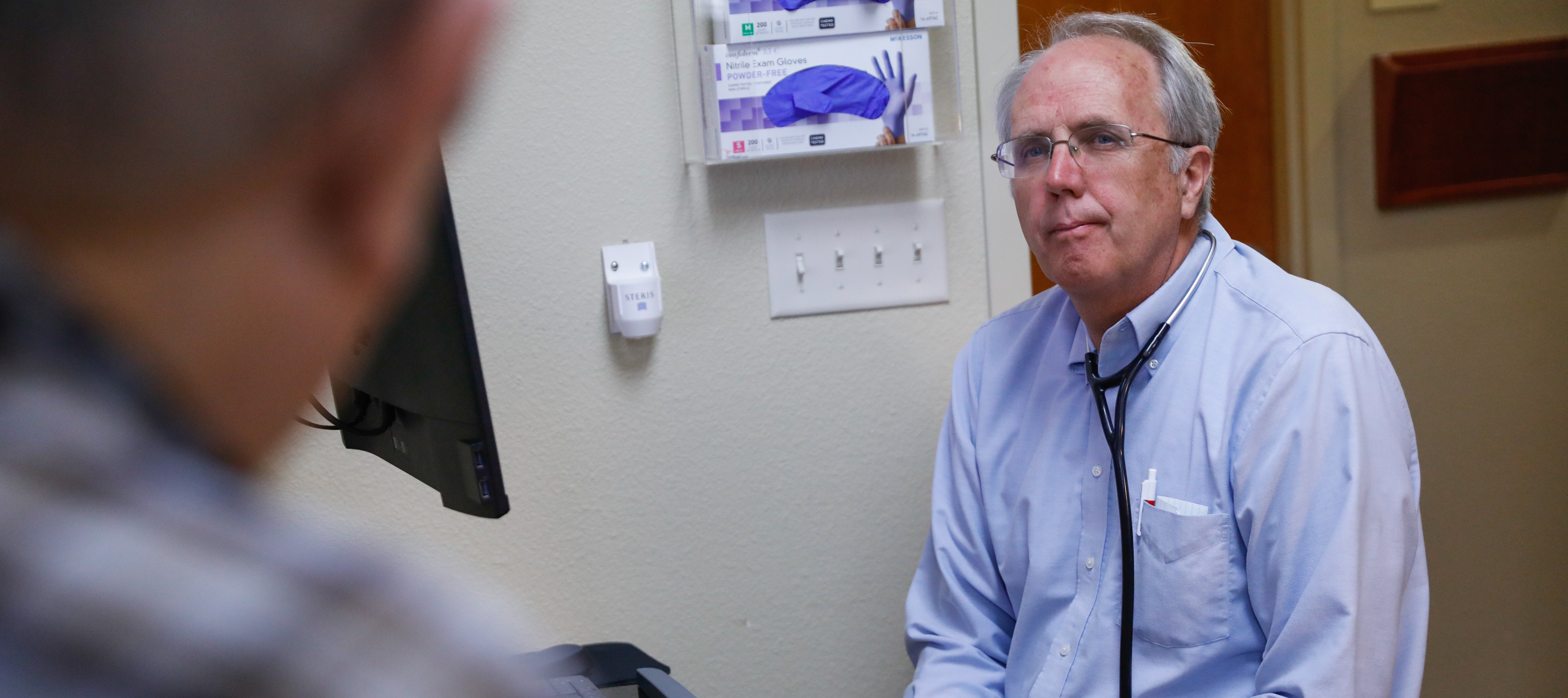 A man meets with his doctor.