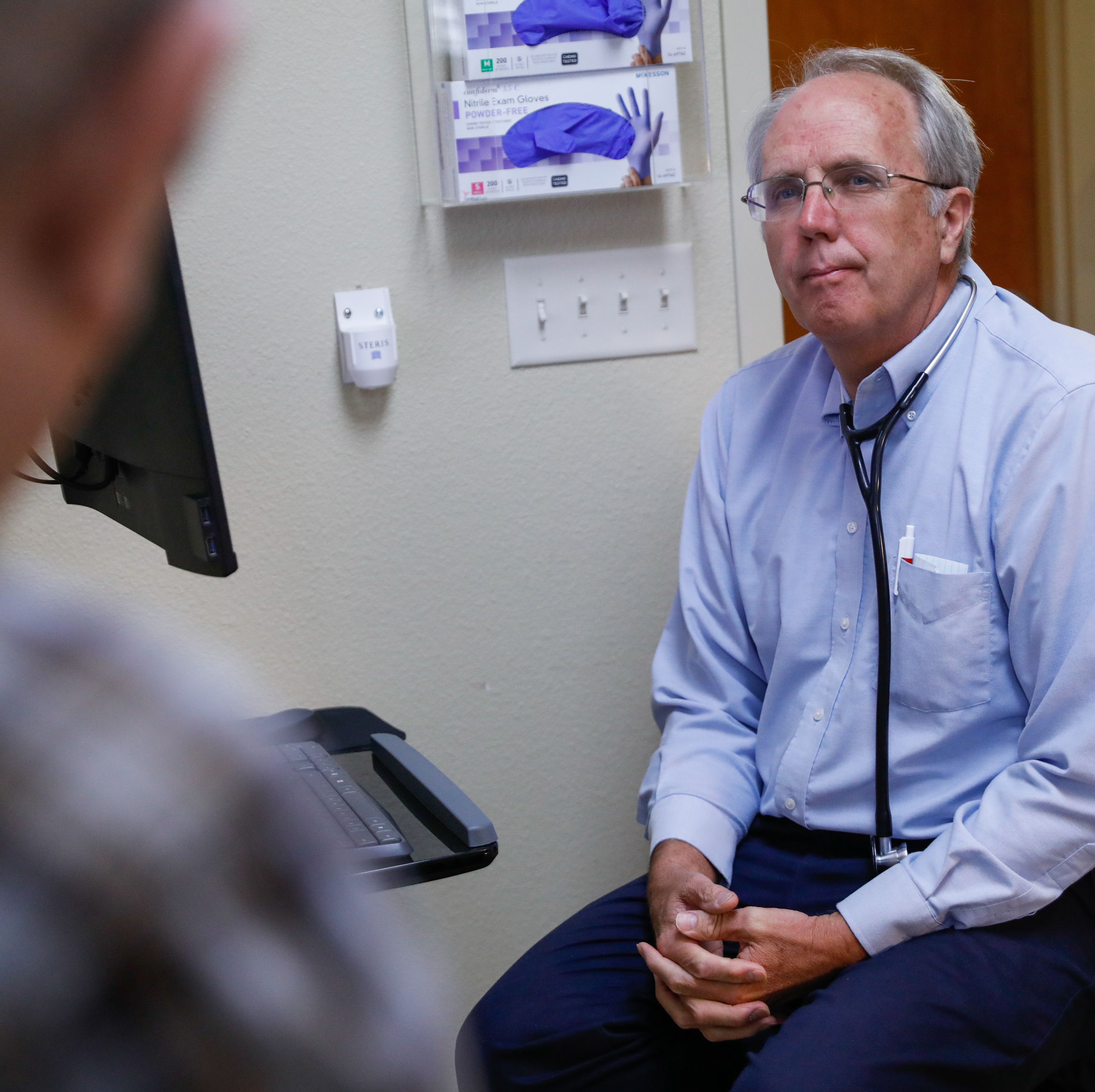 A man meets with his doctor.