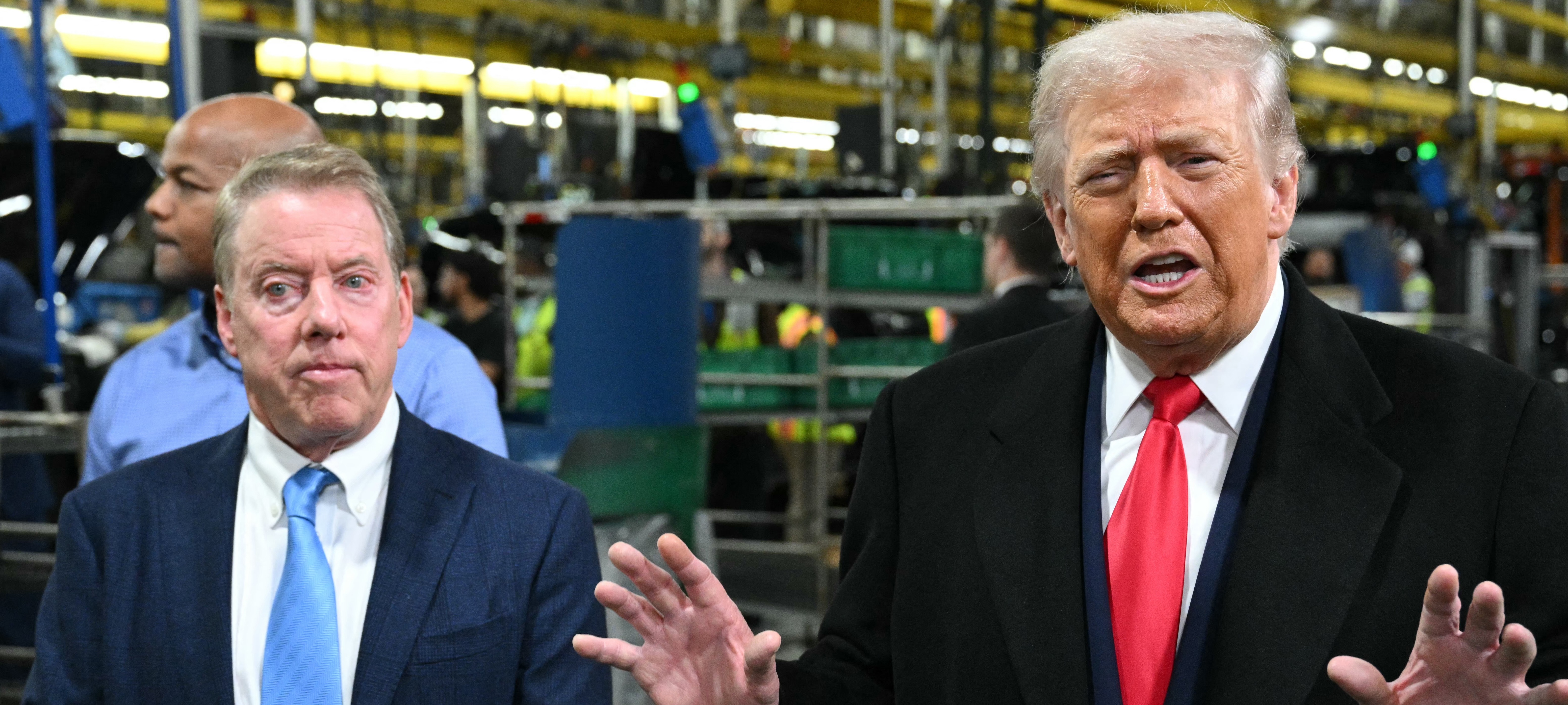 US President Donald Trump speaks alongside Ford executive chairman Bill Ford as he tours plant.