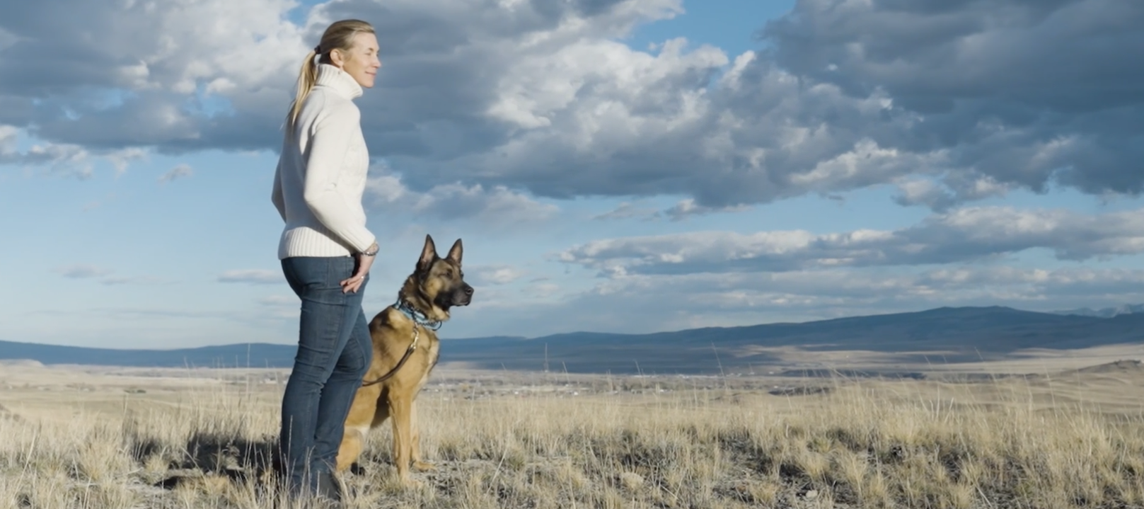 Kim Greene stands with one of her dogs at her training facility in Montana.