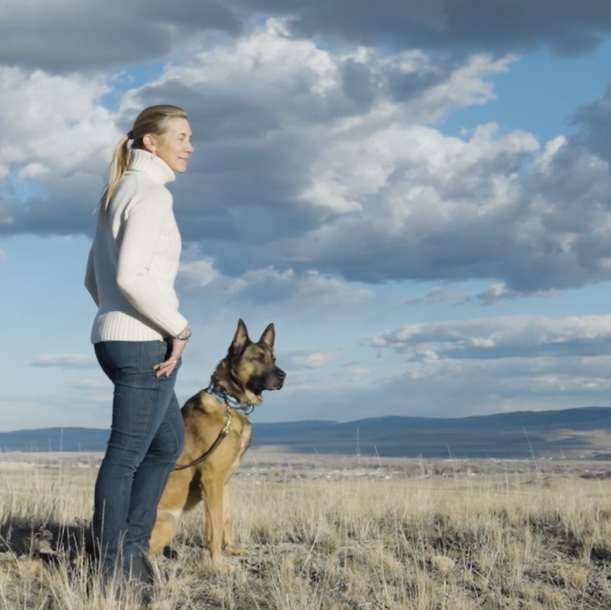 Kim Greene stands with one of her dogs at her training facility in Montana.