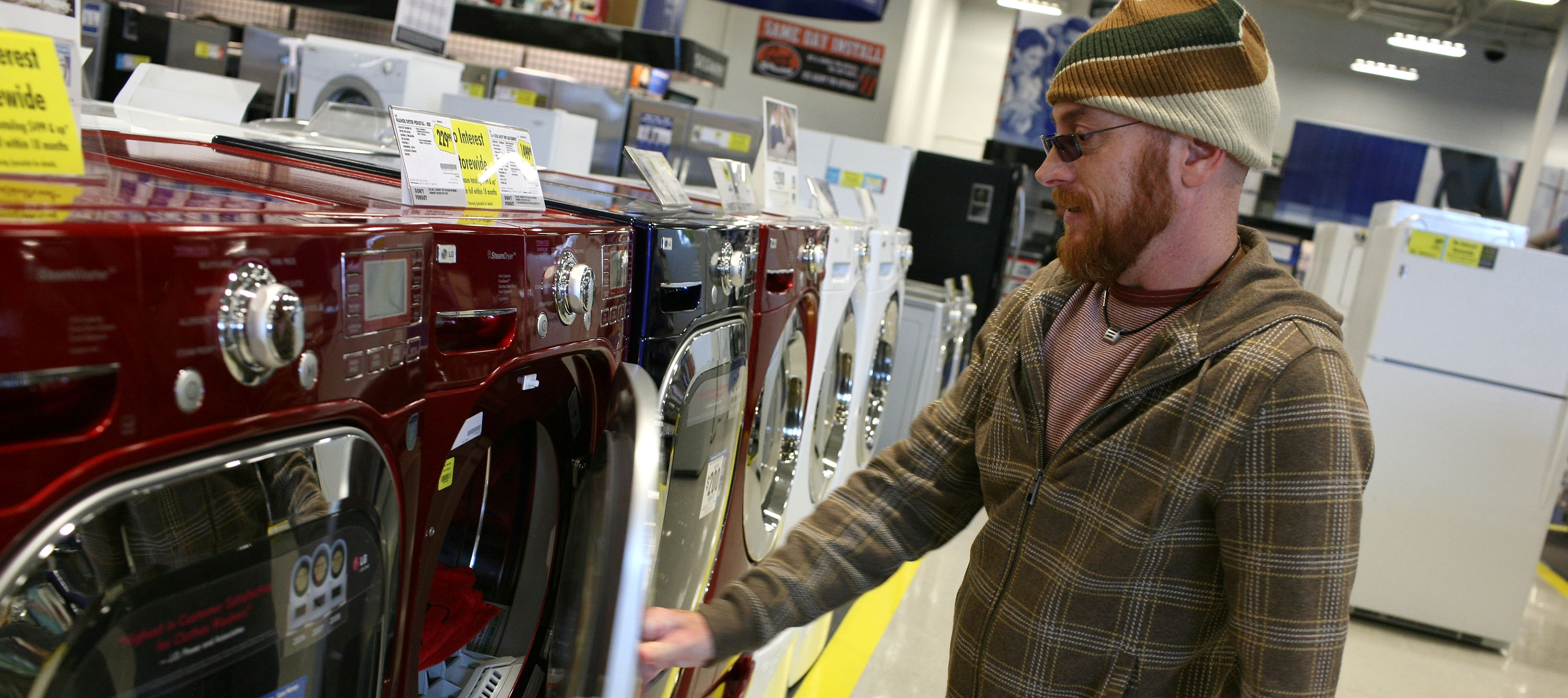 A man checks out a washing machine at Best Buy.