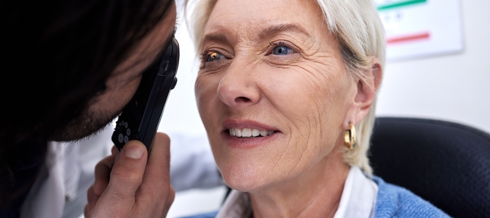An older woman receives an eye exam.