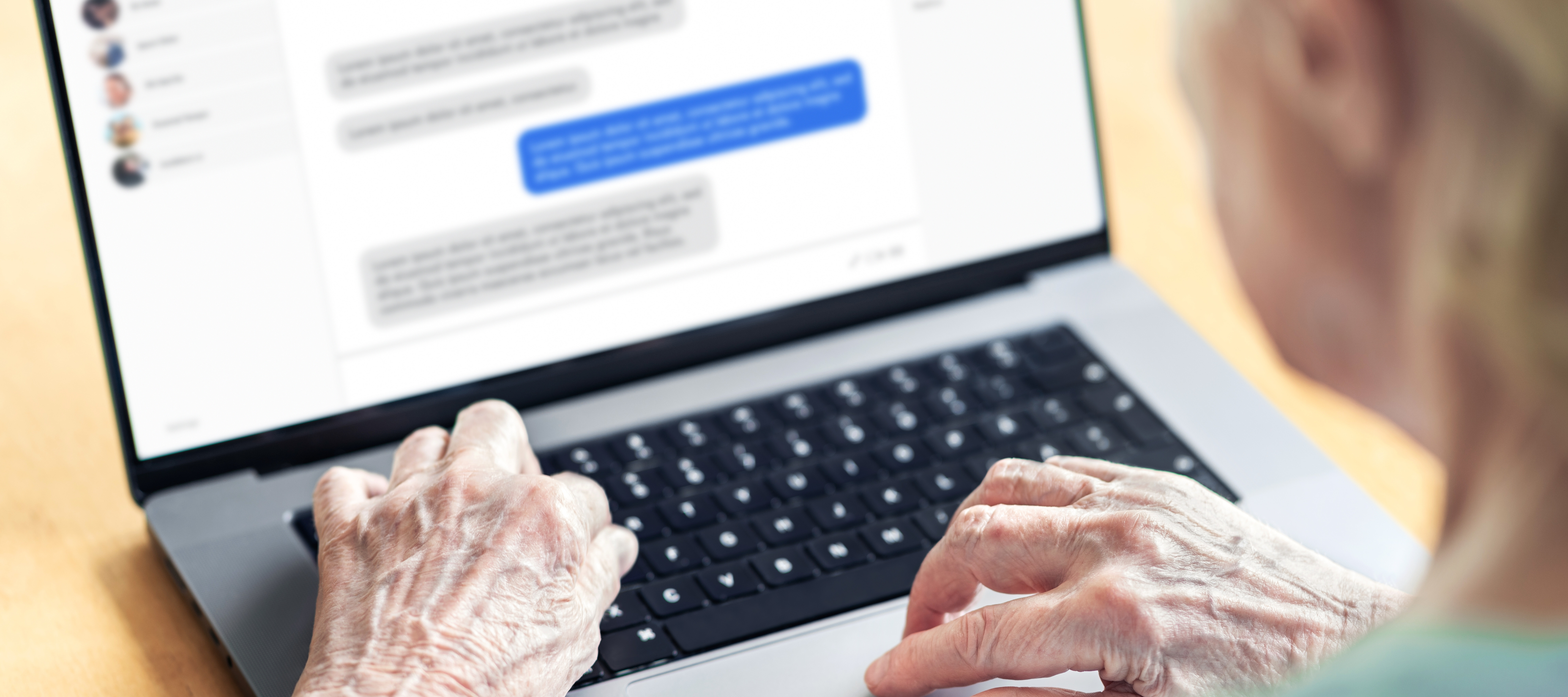 An older American woman exchanges text messages on her computer.