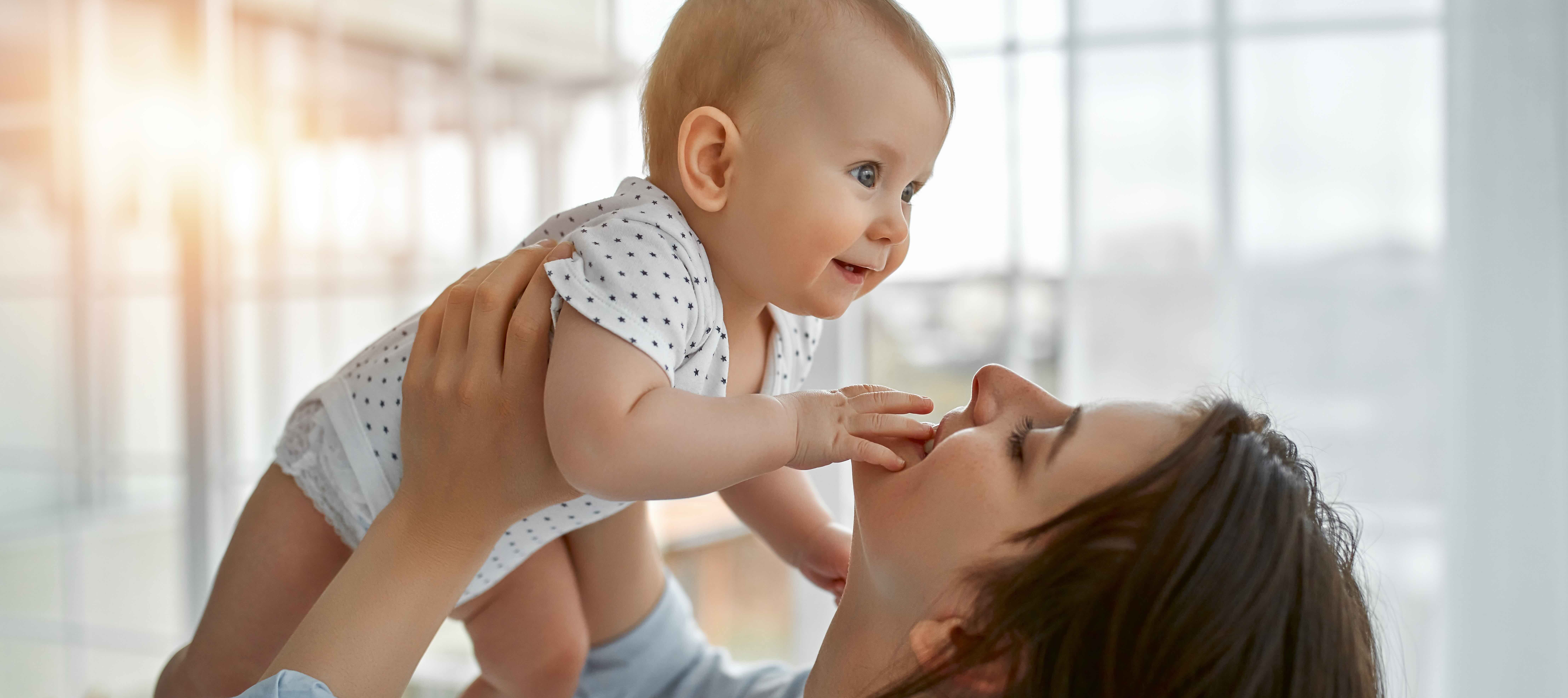 A woman holding a newborn baby at home, when deciding to go back to work can be more or less feasible depending on where in the U.S. you live.