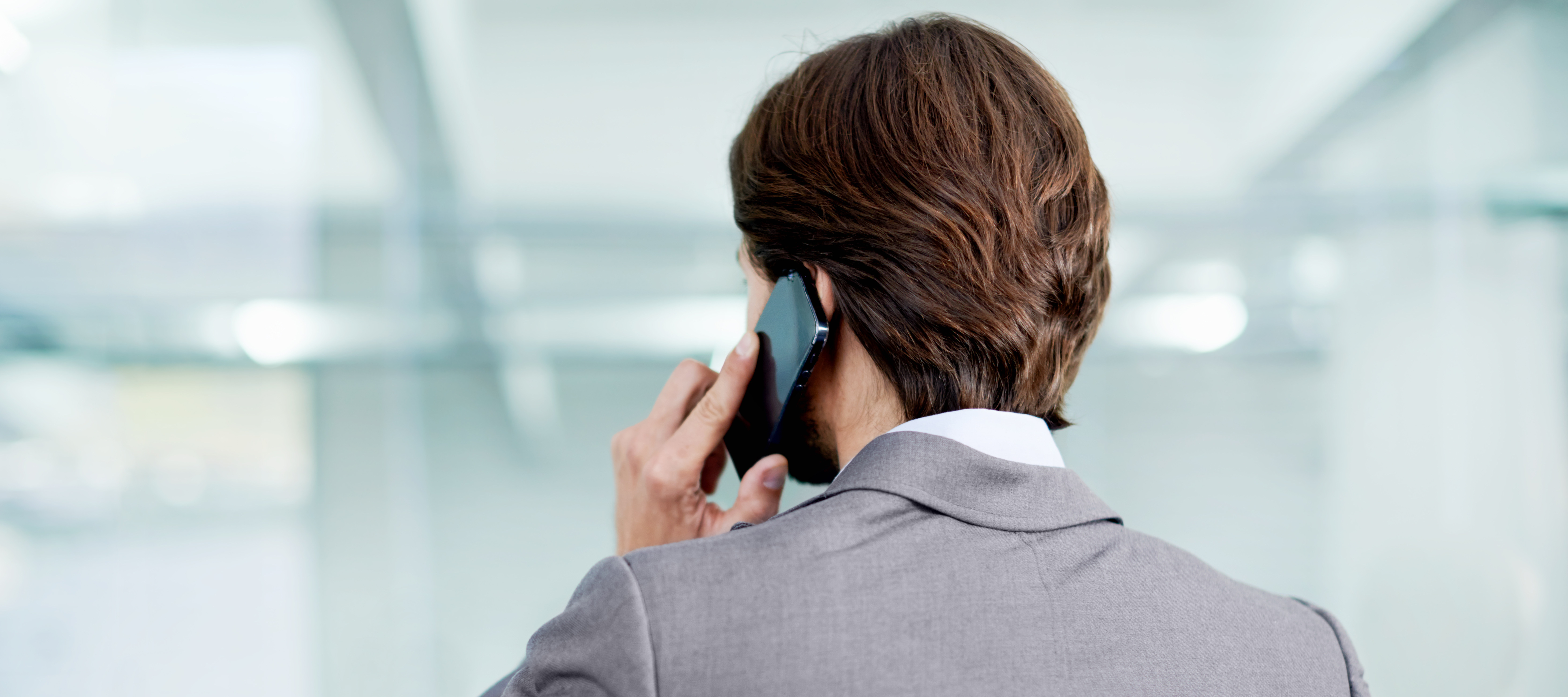 A man talks on the phone while at the office.