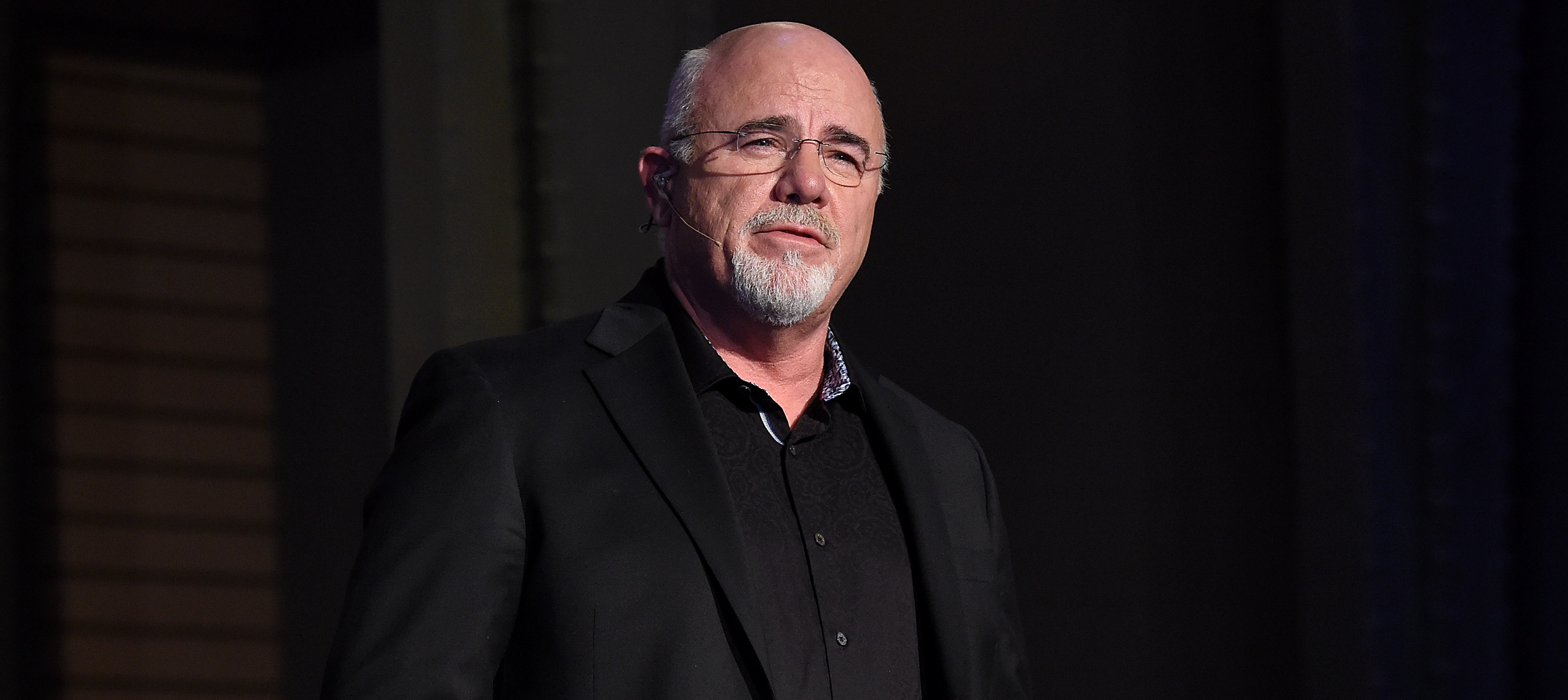 Dave Ramsey speaks on stage during an event.