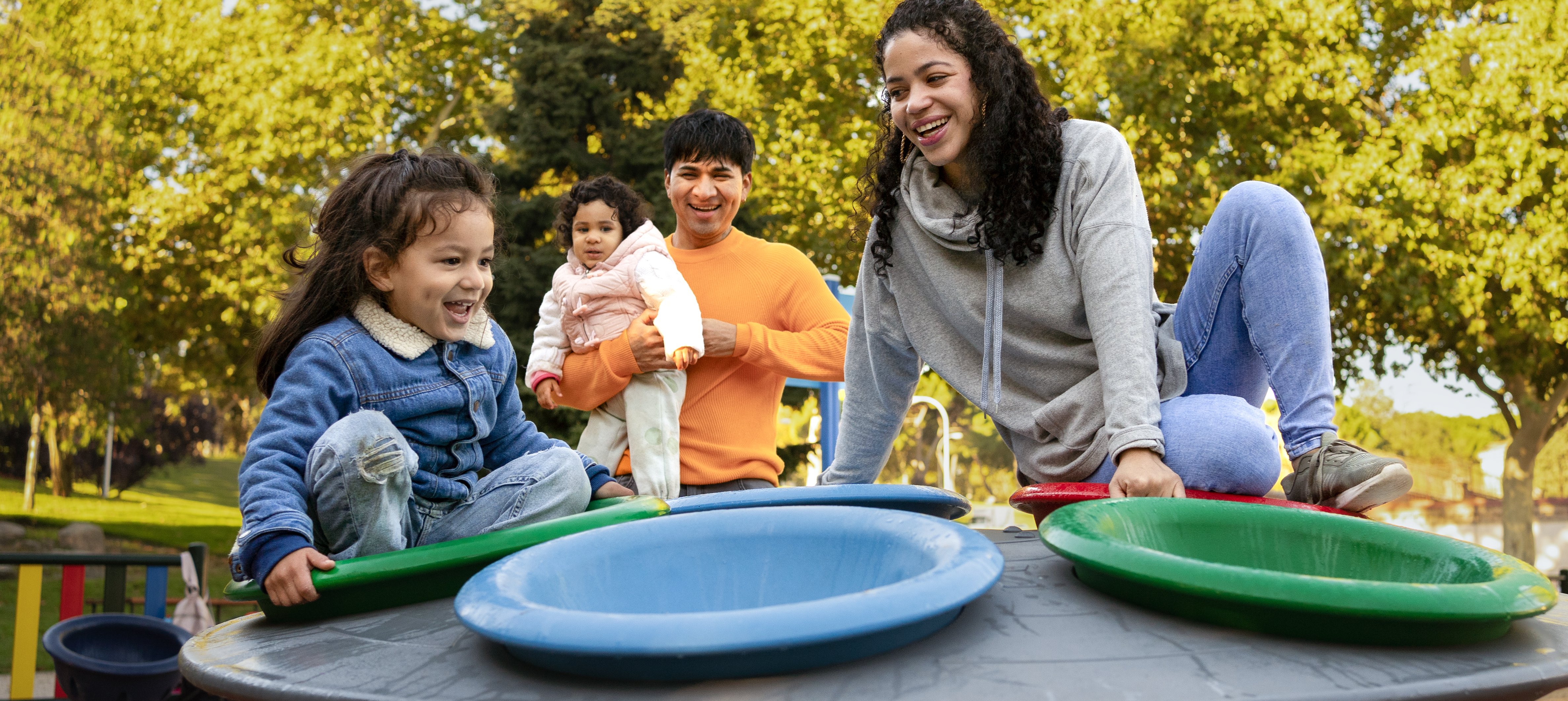 A family of four enjoying a play ground, with family fun part just one metric used by WalletHub to determine best and worst states to raise a family in 2026.