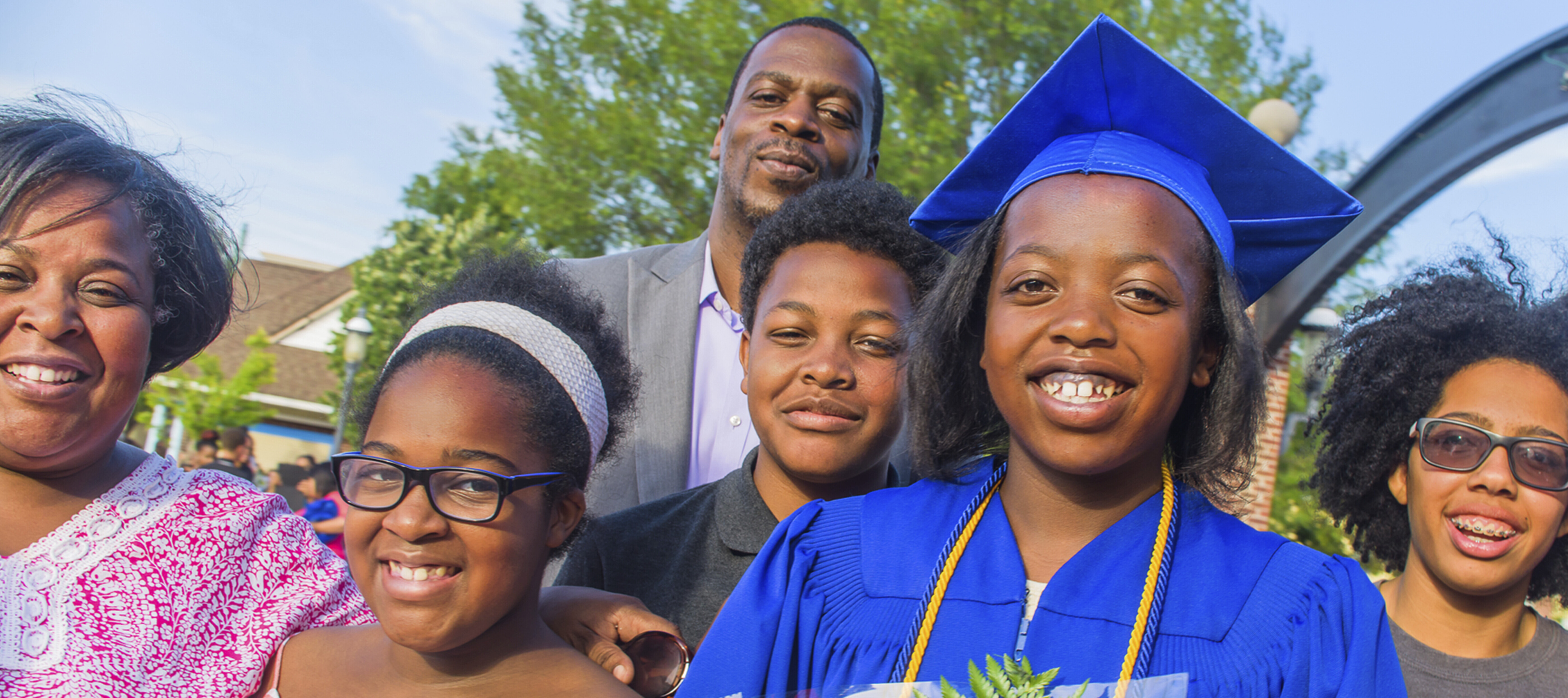 A high school graduate celebrates with her family.