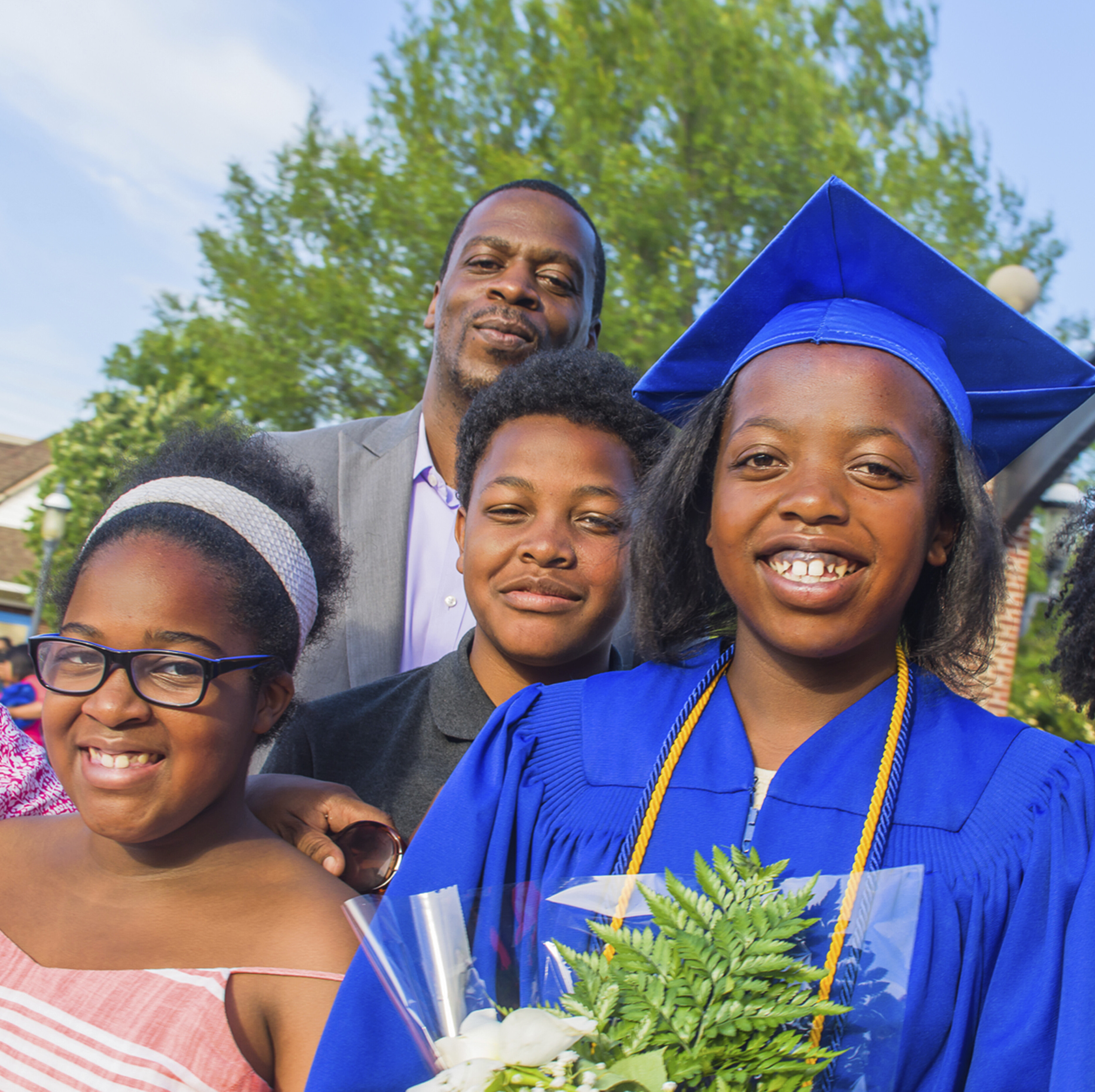 A high school graduate celebrates with her family.