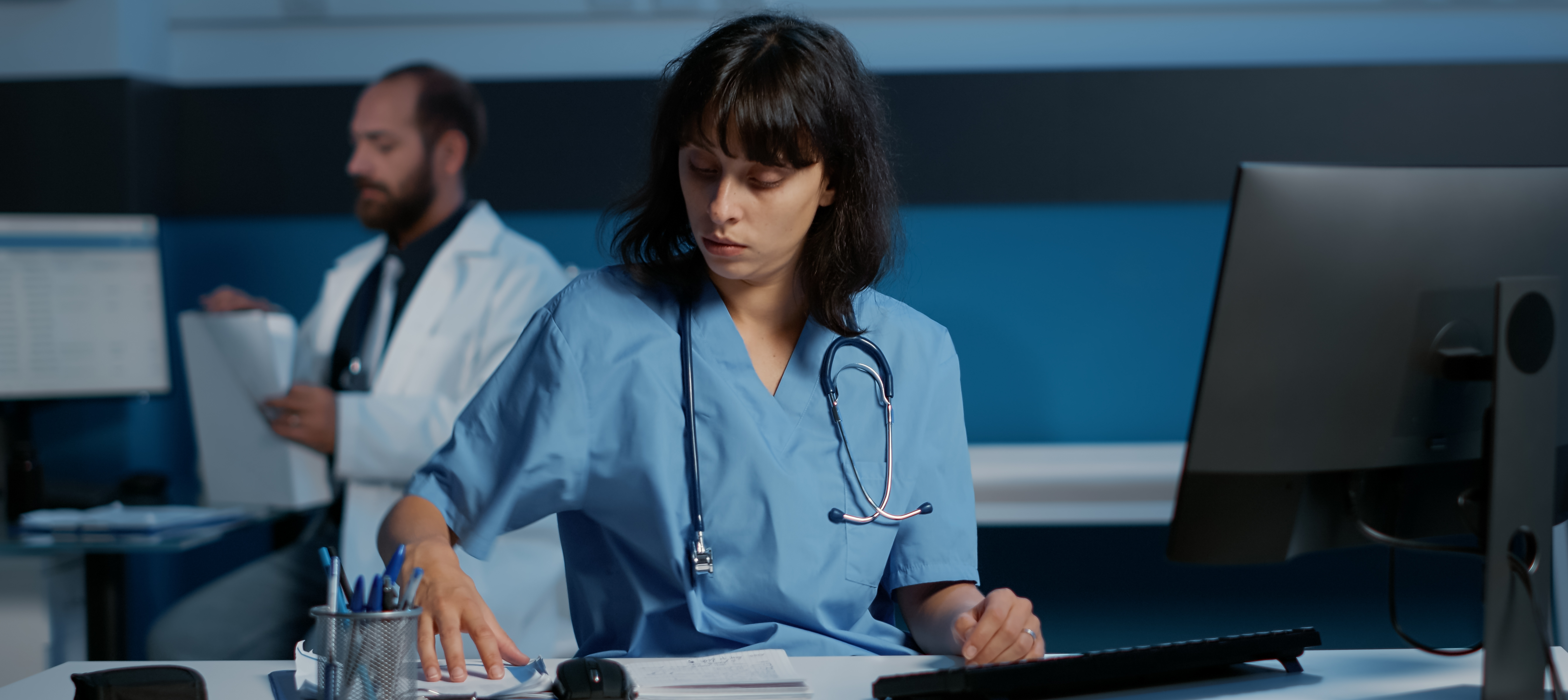 Medical assistant analyzing paperworks.