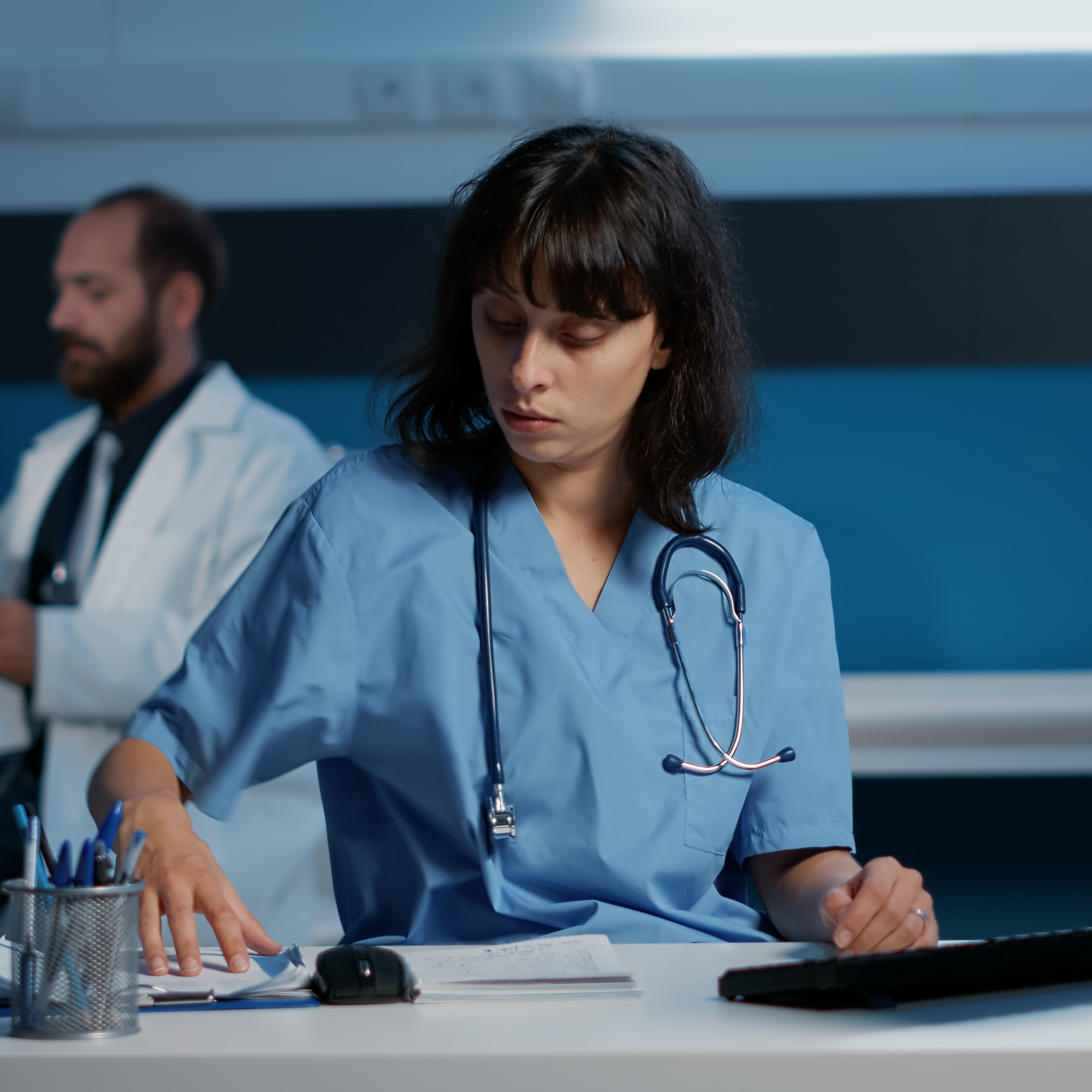 Medical assistant analyzing paperworks.