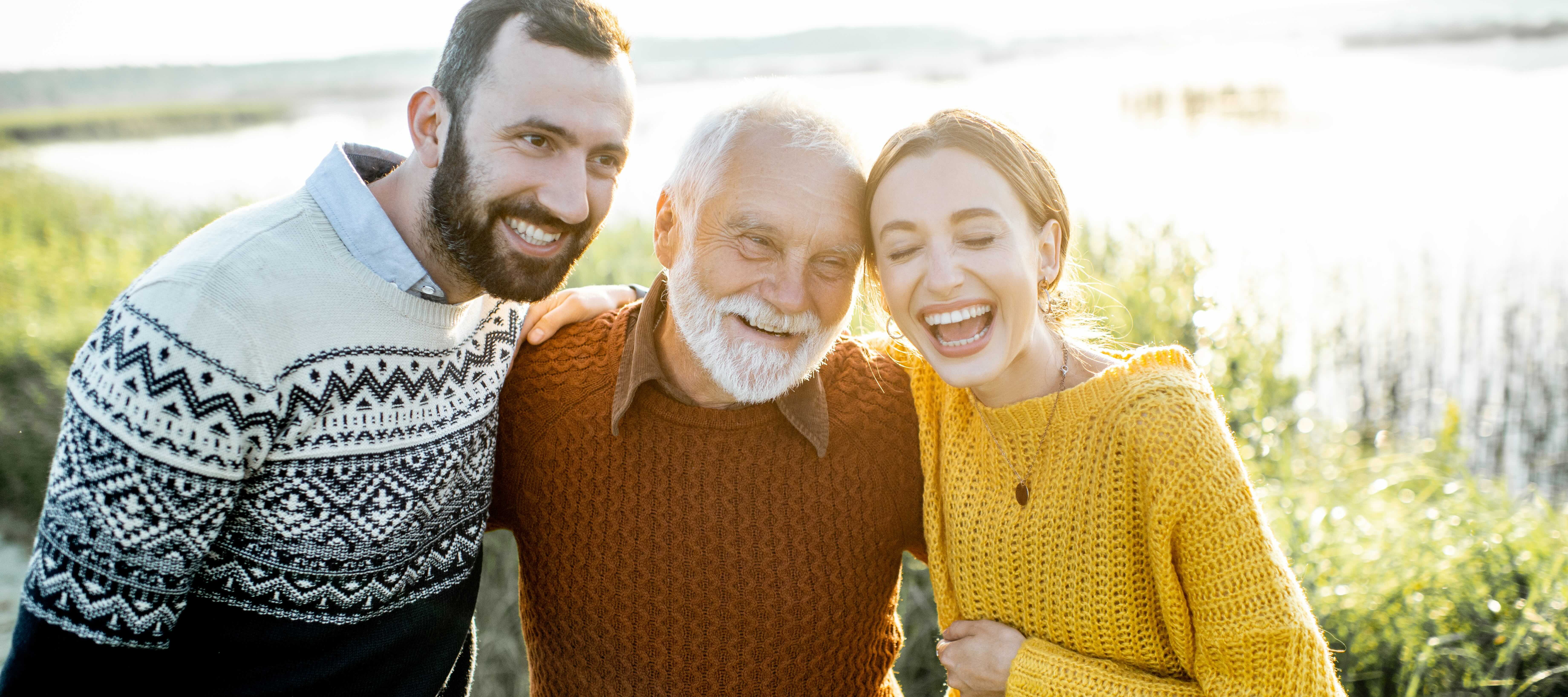 Grandfather spending time with his adult grandchildren on as sunny day.