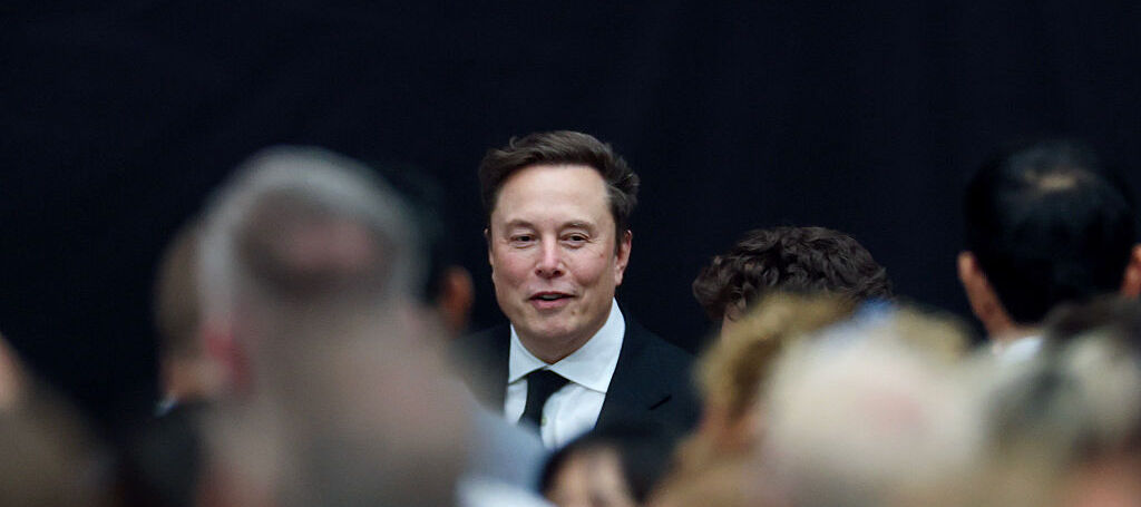 Elon Musk standing among a crowd in September 2025.