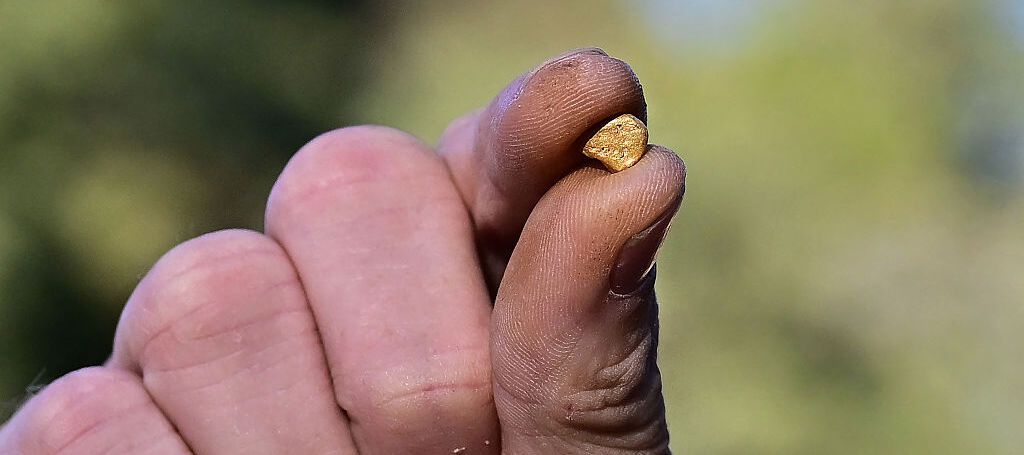 Cody Blanchard displays a gold nugget he found using his metal detector in Sacramento, California.