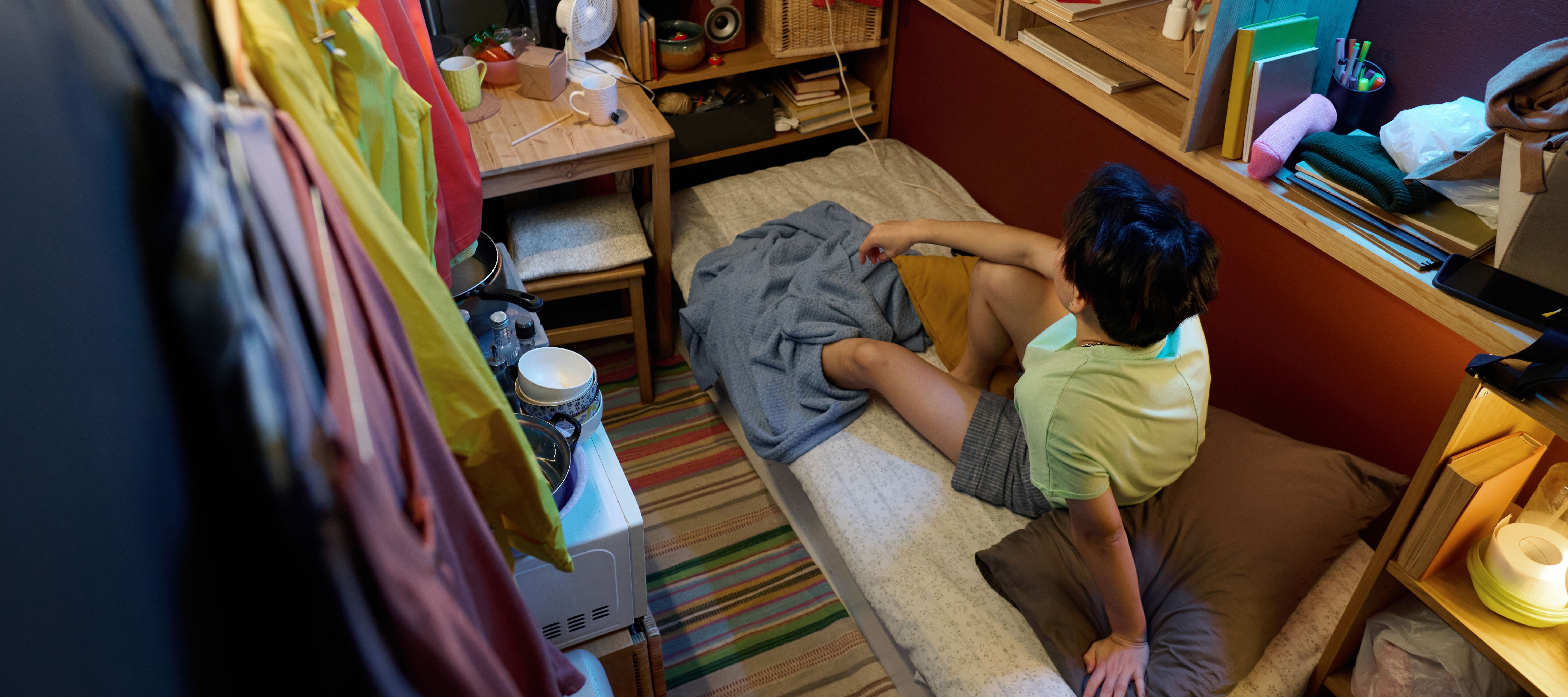 Young person in cramped apartment.