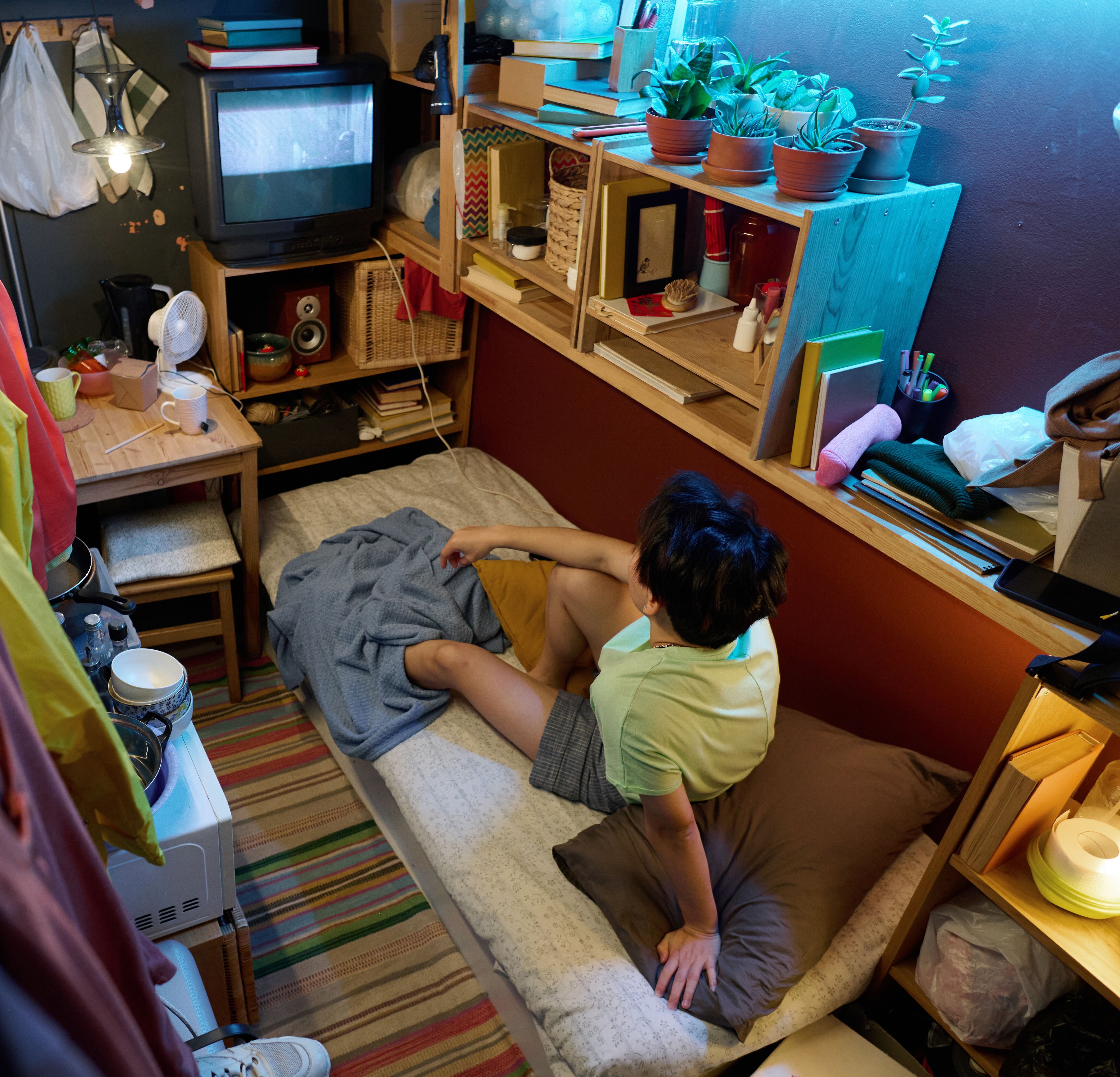 Young person in cramped apartment.
