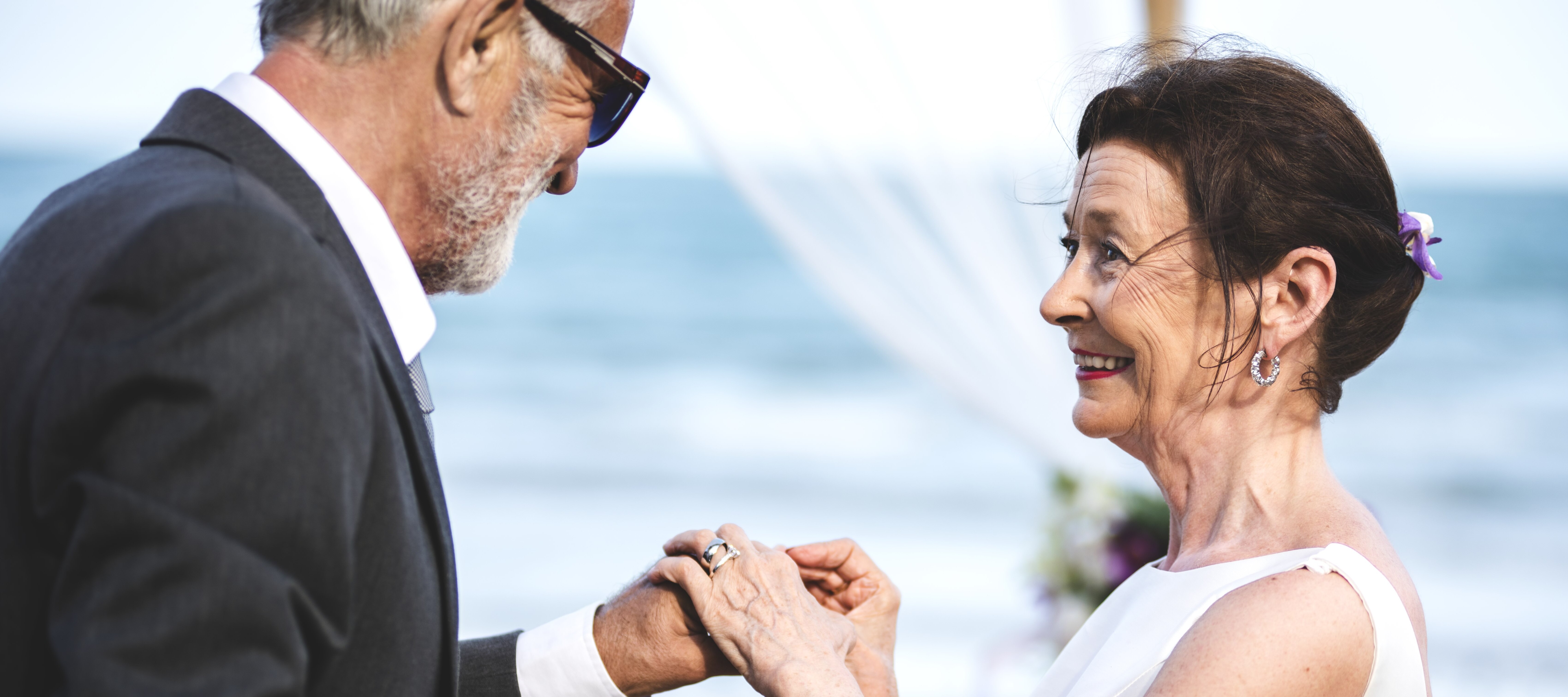 65-year-old couple getting married on a beach.