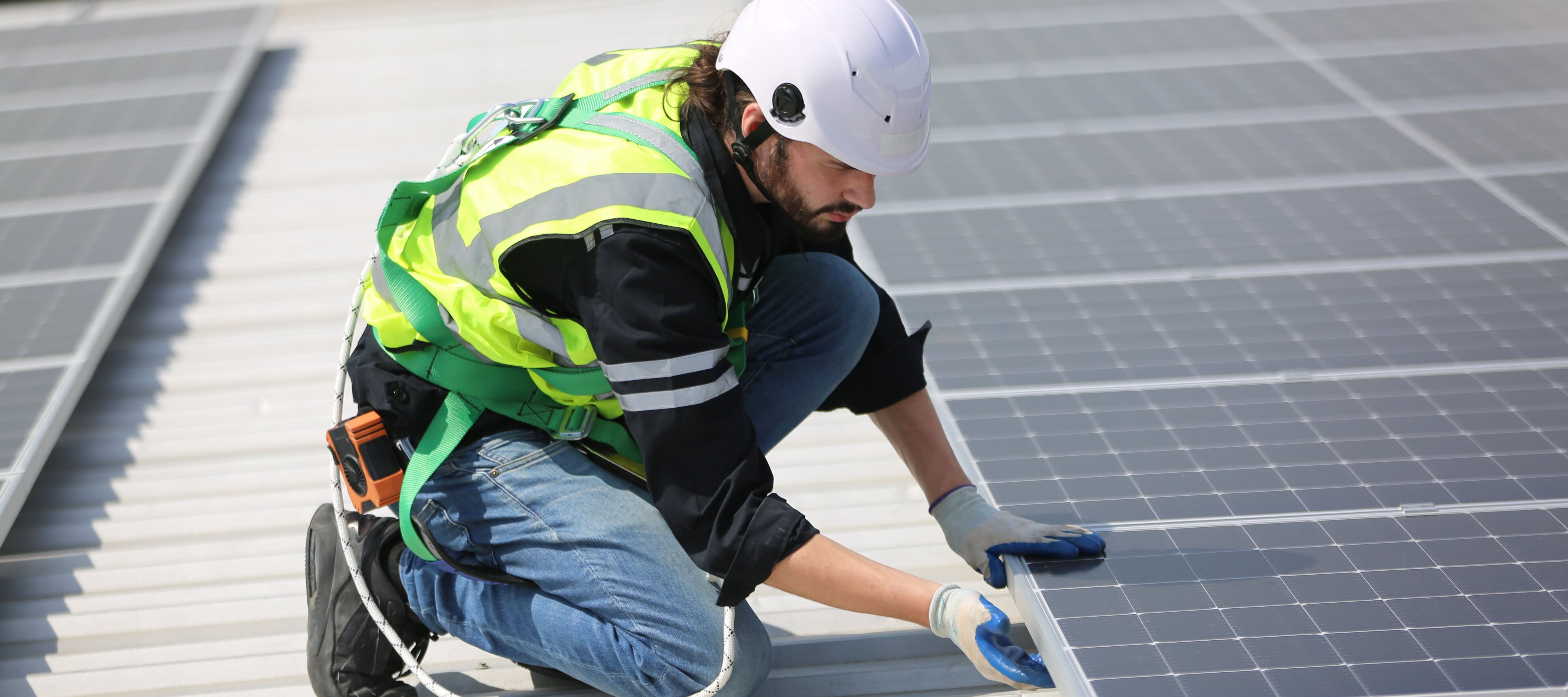 Young man installing solar panels.