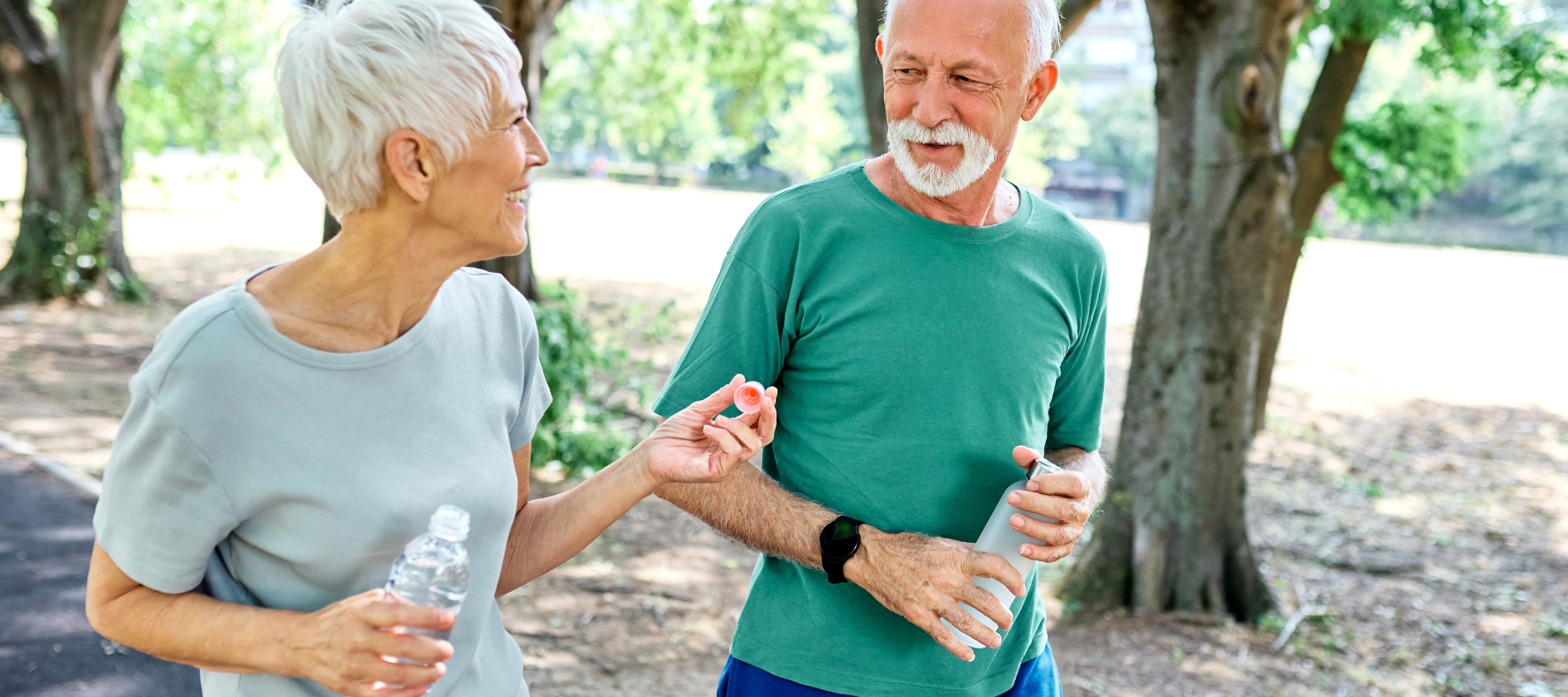 A couple enjoys a walk on a sunny day.