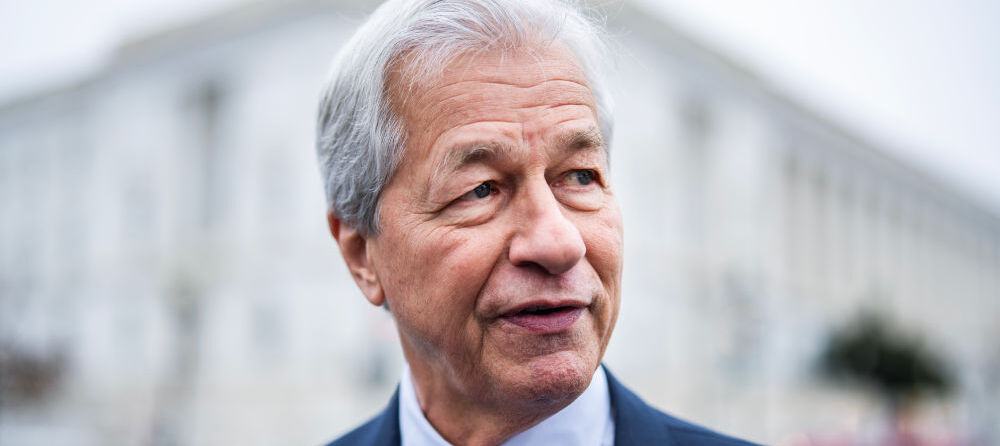 JPMorgan Chase CEO Jamie Dimon looks to the left in a blue suit with red tie.