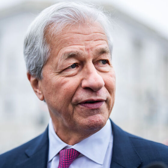 JPMorgan Chase CEO Jamie Dimon looks to the left in a blue suit with red tie.
