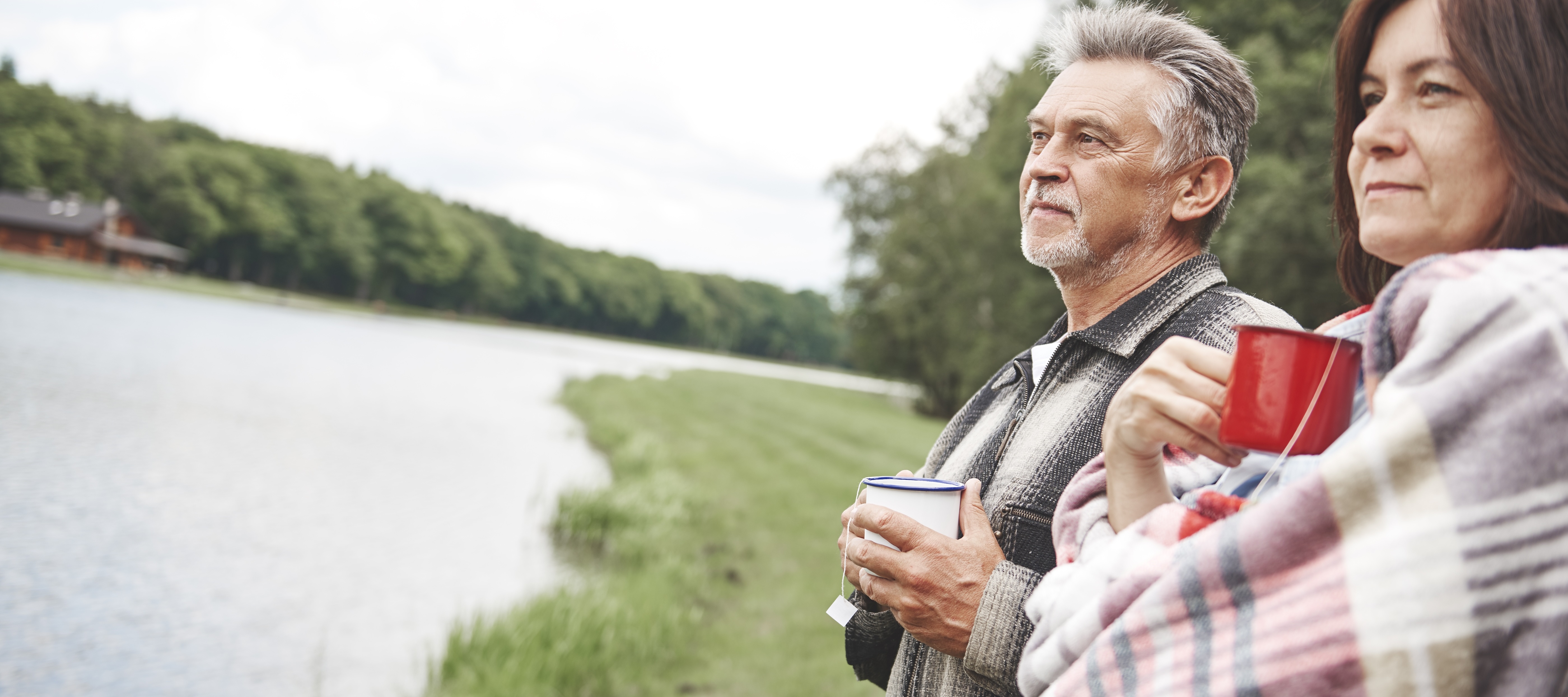 Near-retirement couple drinking tea outside on a trip