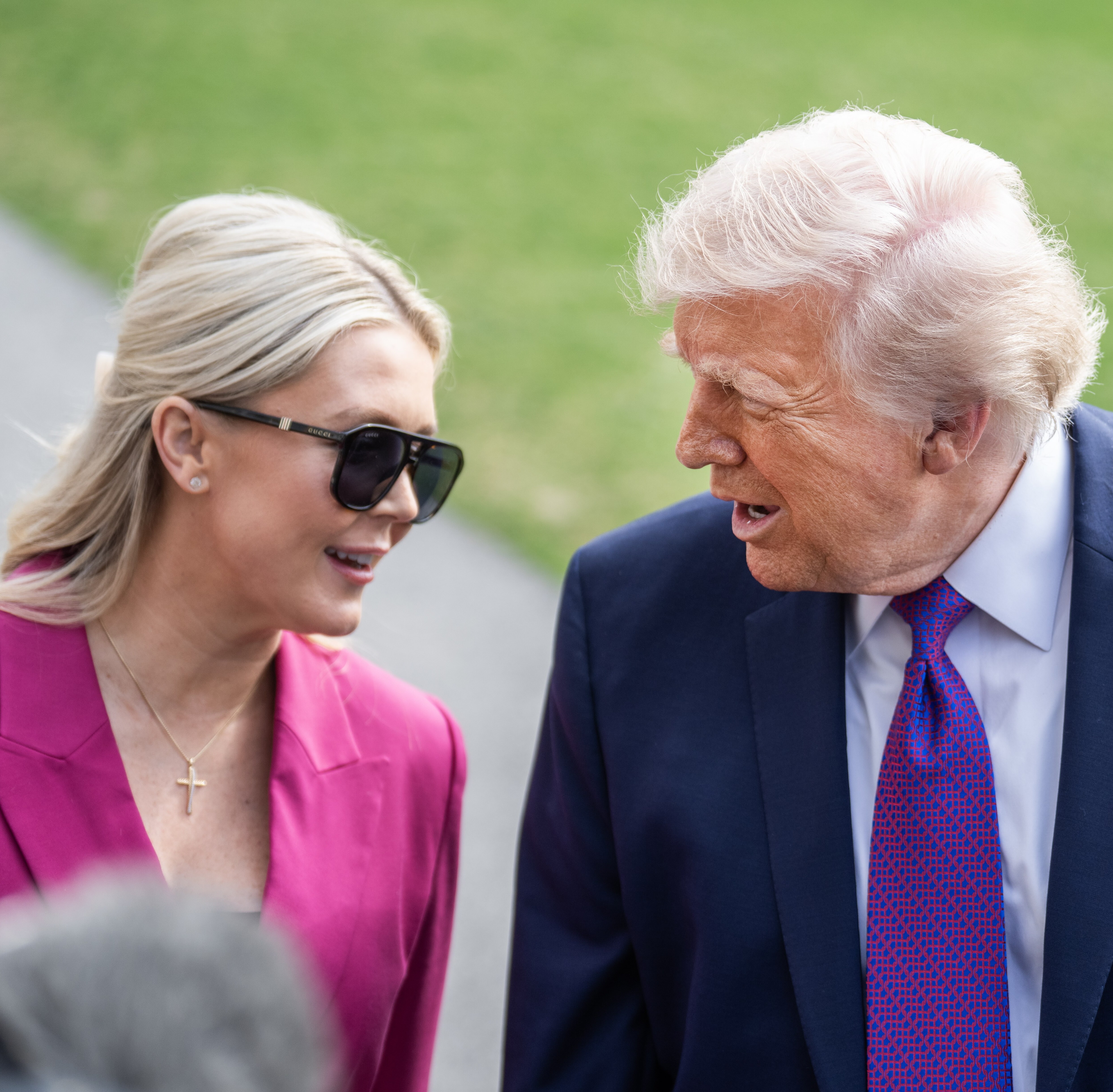 Karoline Leavitt, White House press secretary, and President Donald Trump speak with reporters on the South Lawn of the White House before boarding Marine One.