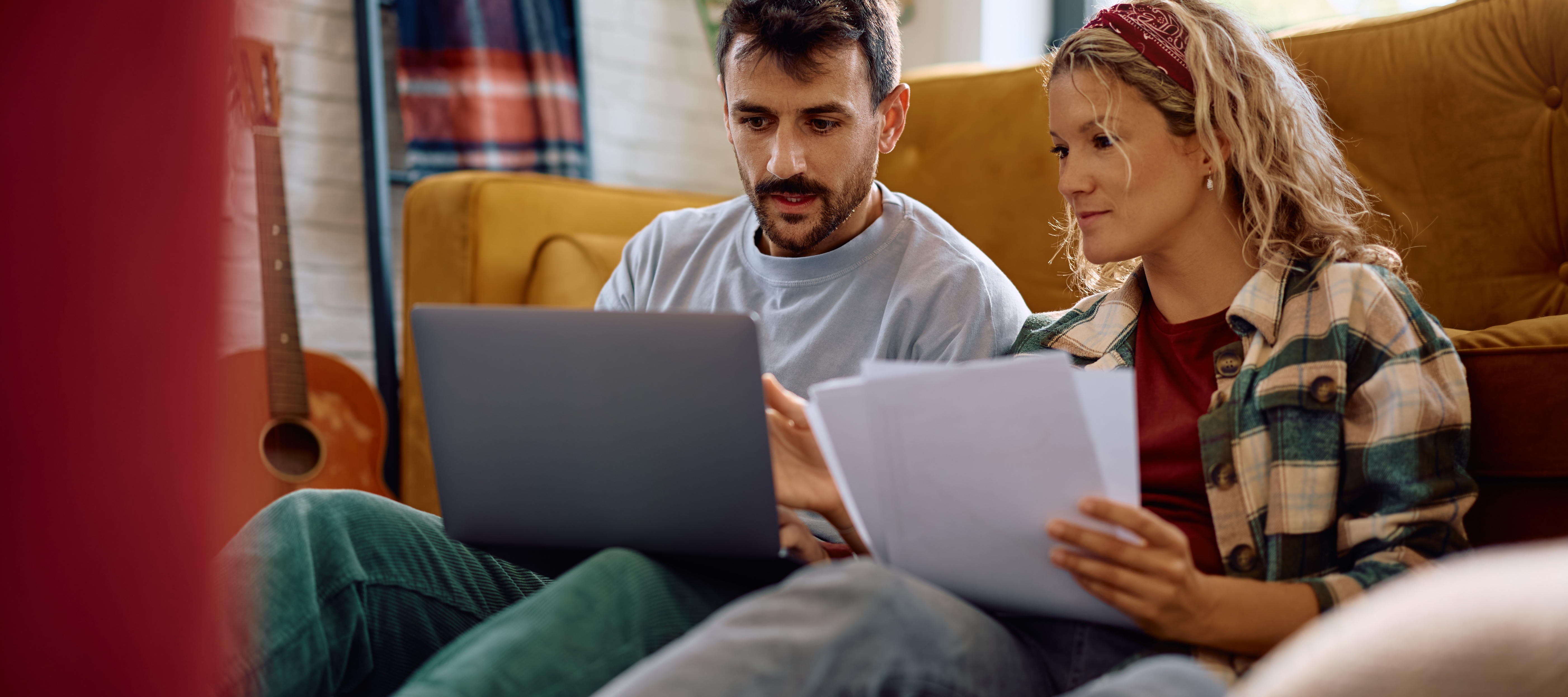 Young couple looking at credit reports and bills together.