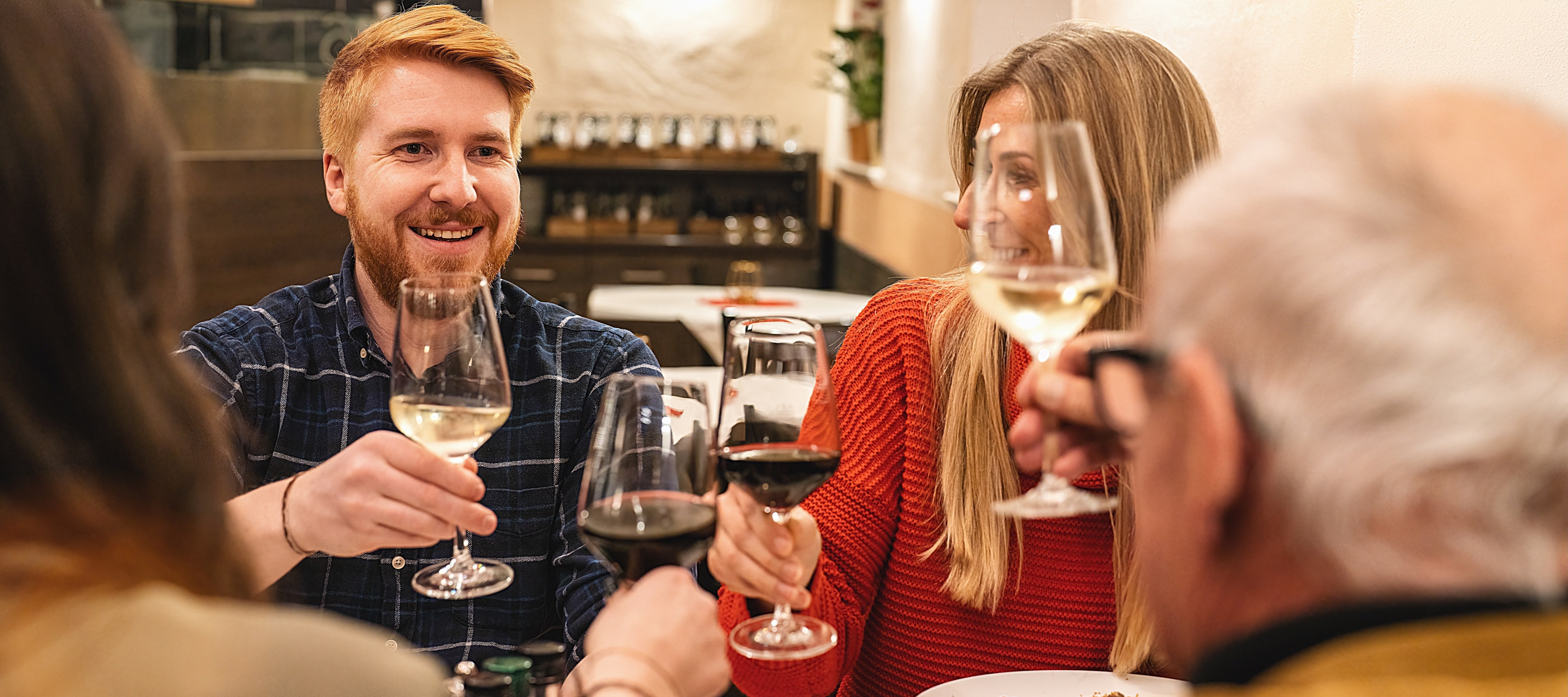 A wealthy multigenerational family at a dinner, toasting to their good fortunes.