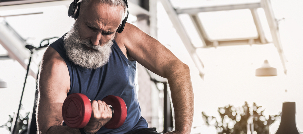 Retired man working out in home gym.