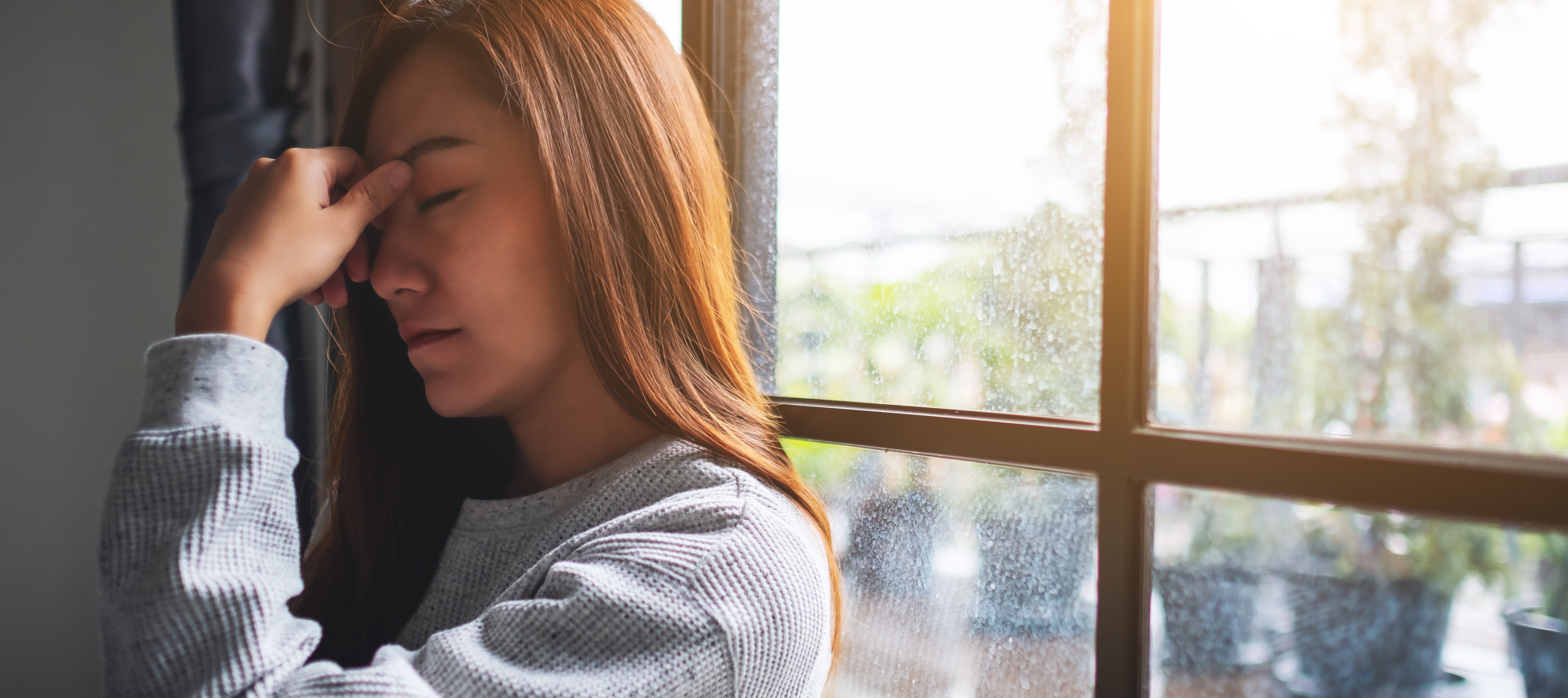 Stressed woman holding her head.