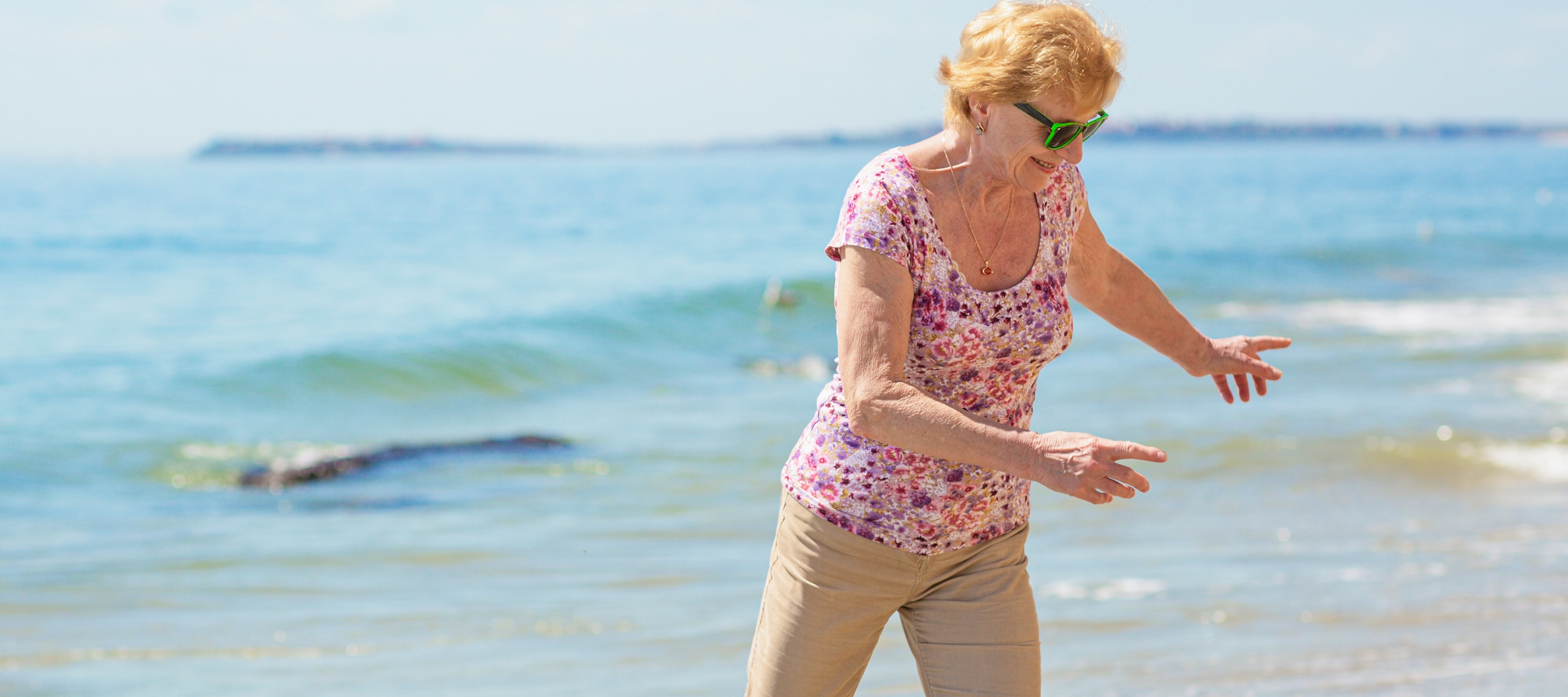 Older woman enjoying her retirement on the beach.