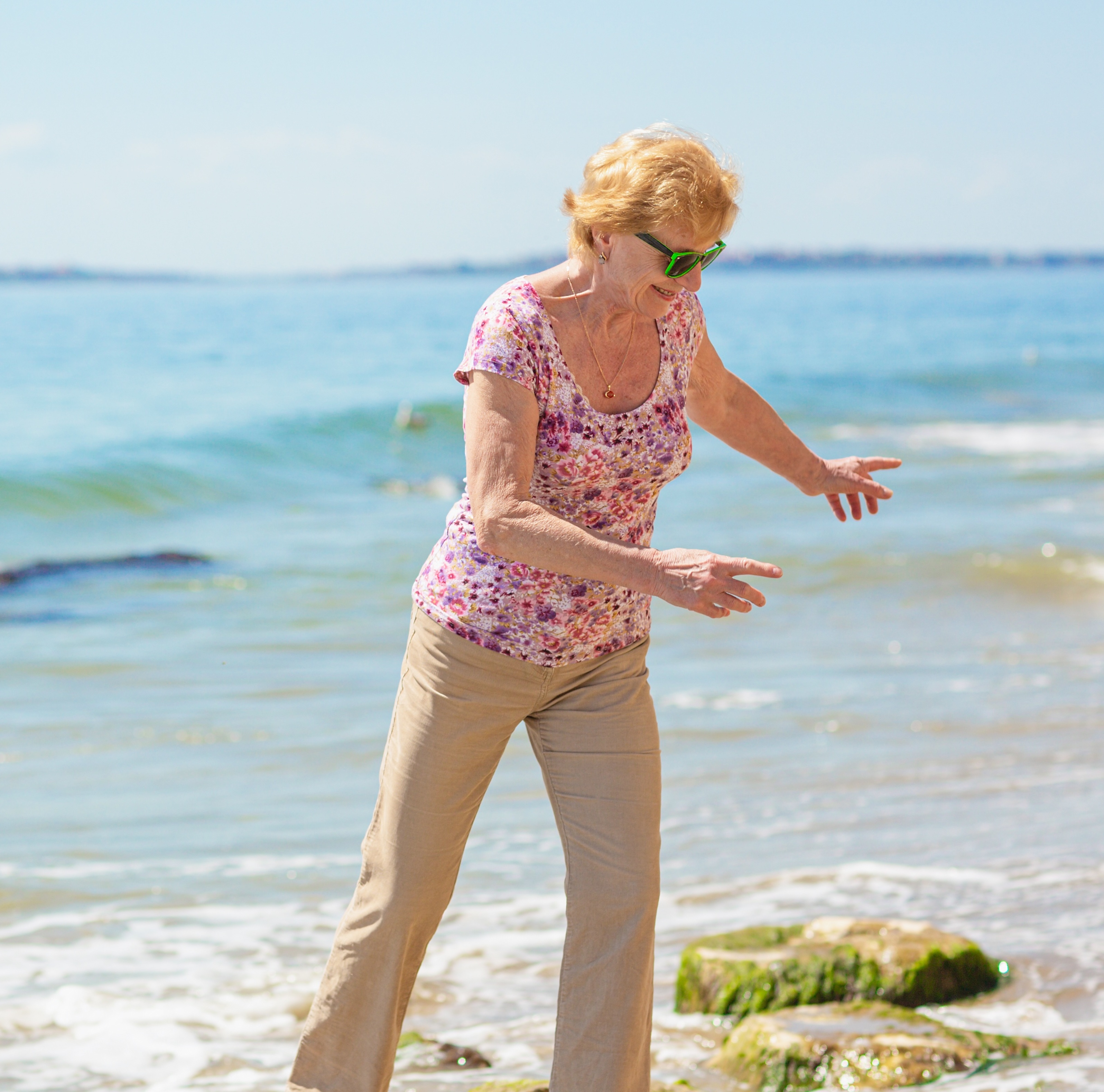 Older woman enjoying her retirement on the beach.