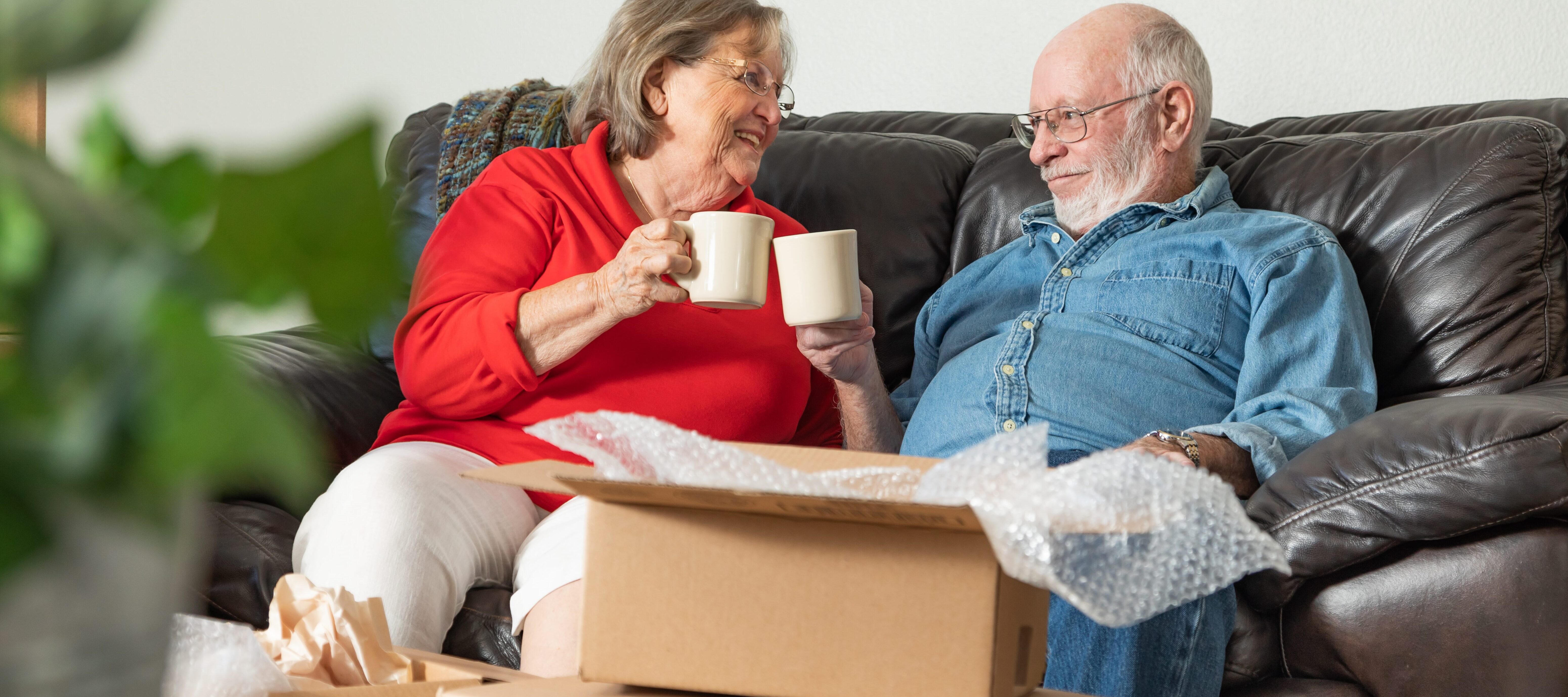 Retired couple next to moving boxes