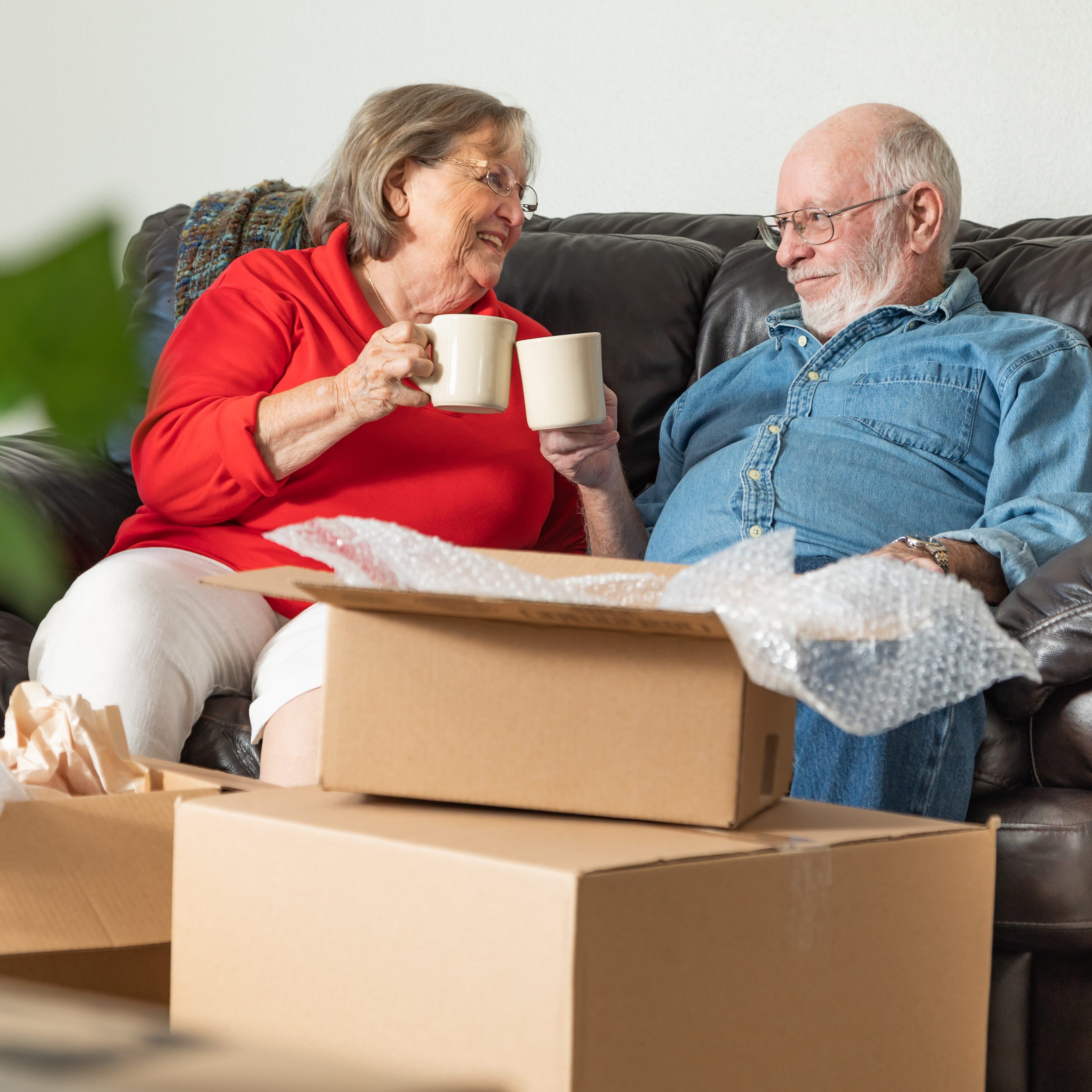 Retired couple next to moving boxes