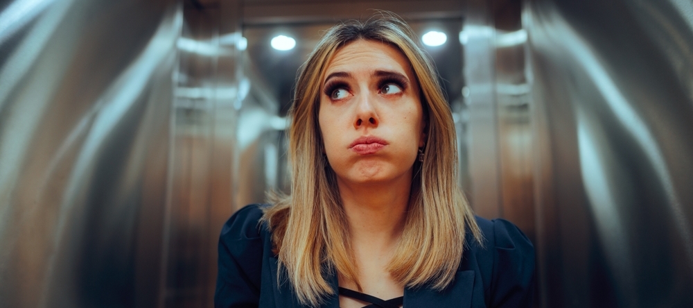 Anxious Office Worker Riding an Elevator