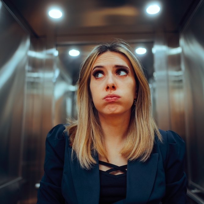 Anxious Office Worker Riding an Elevator