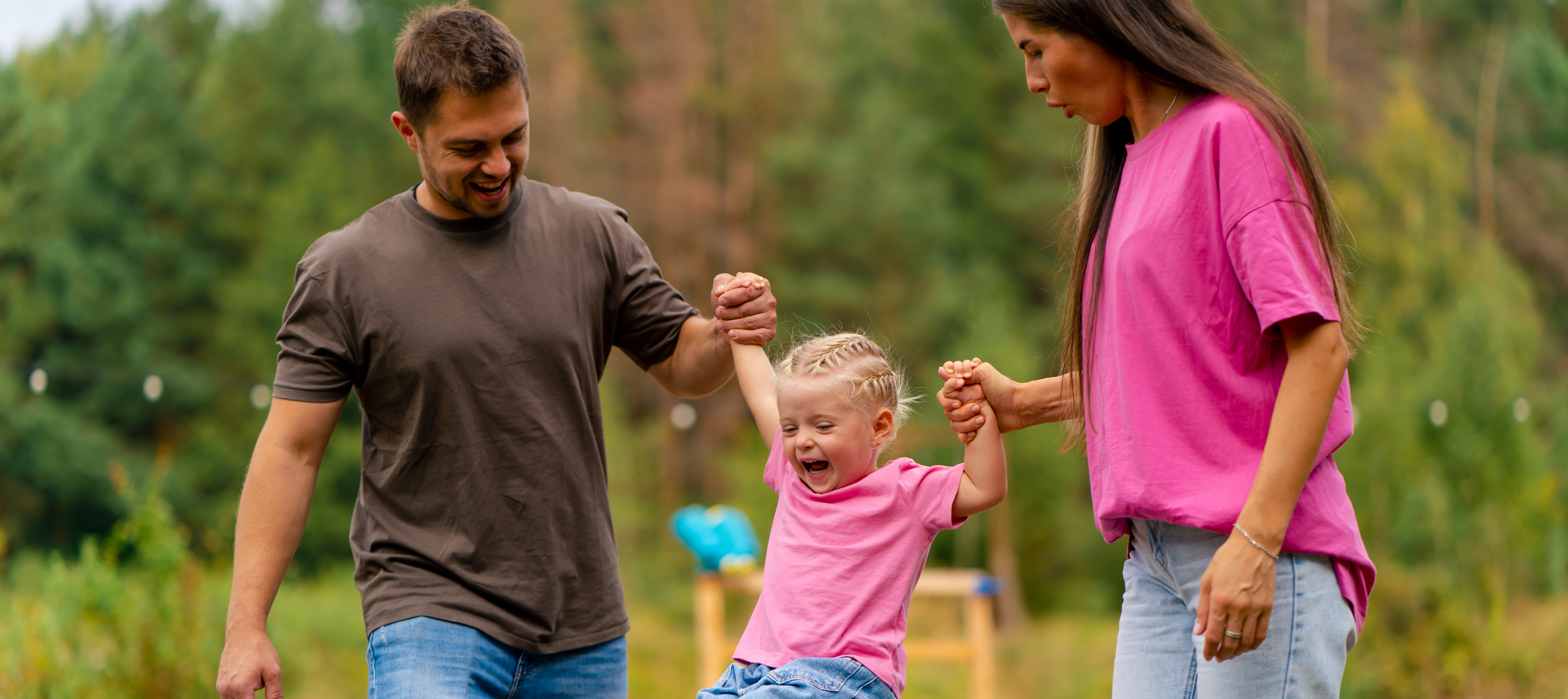 A young family enjoys a day at the park.