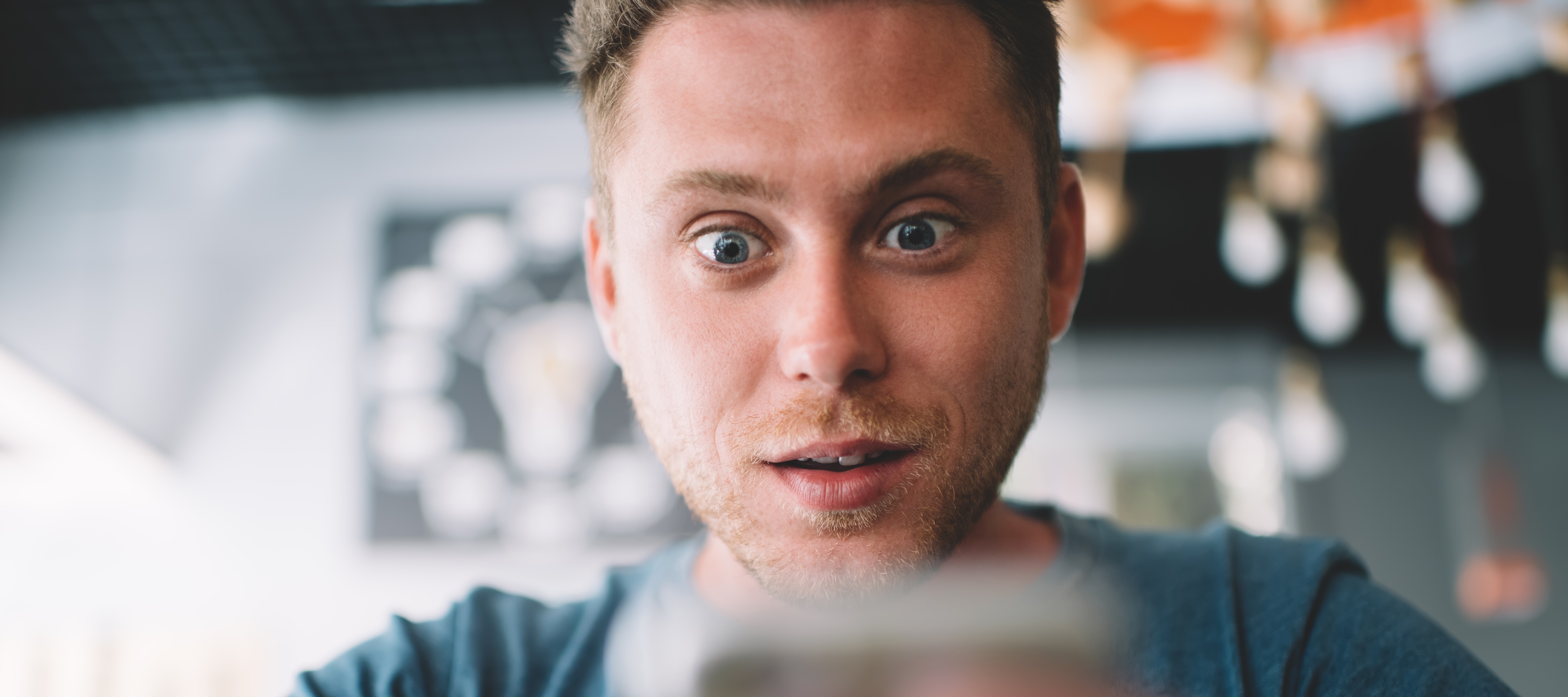 Shocked man looking at his phone.