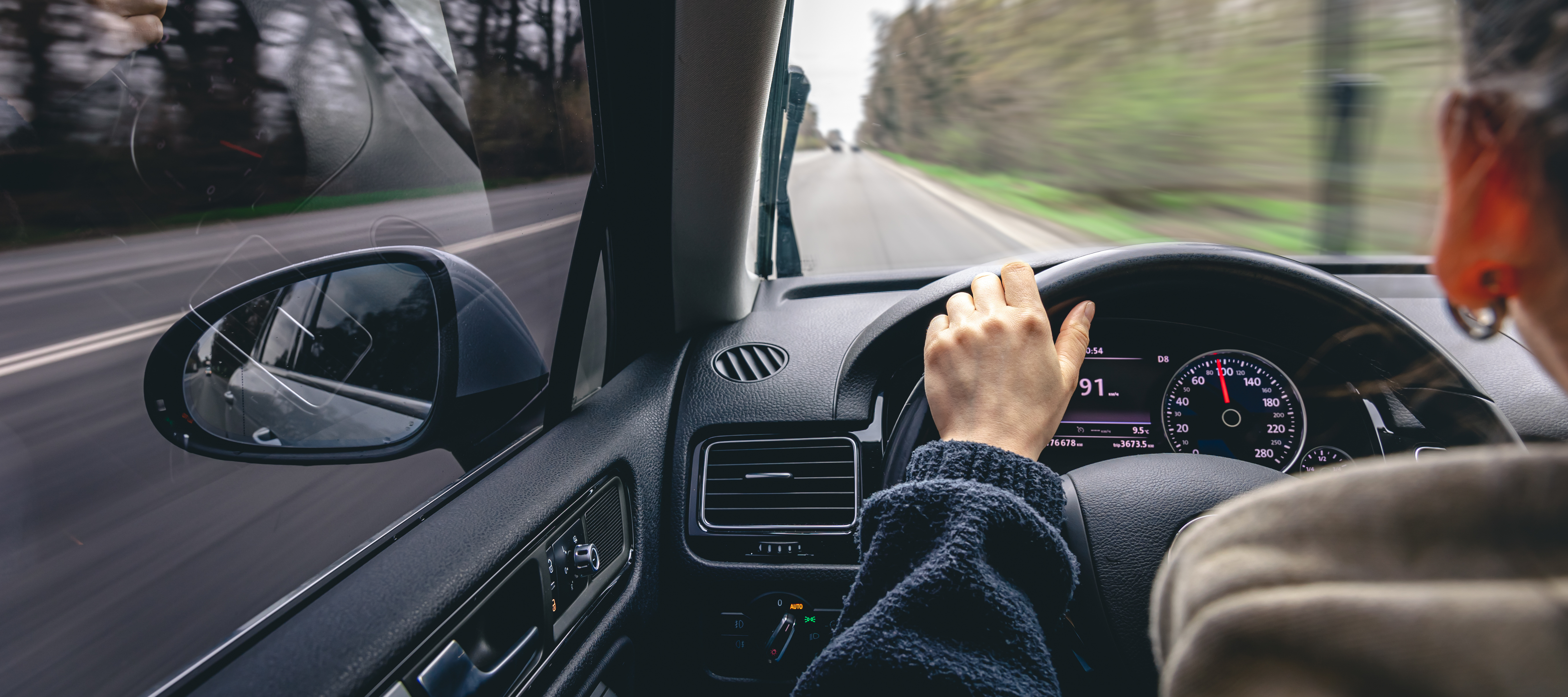 A woman driving her car.