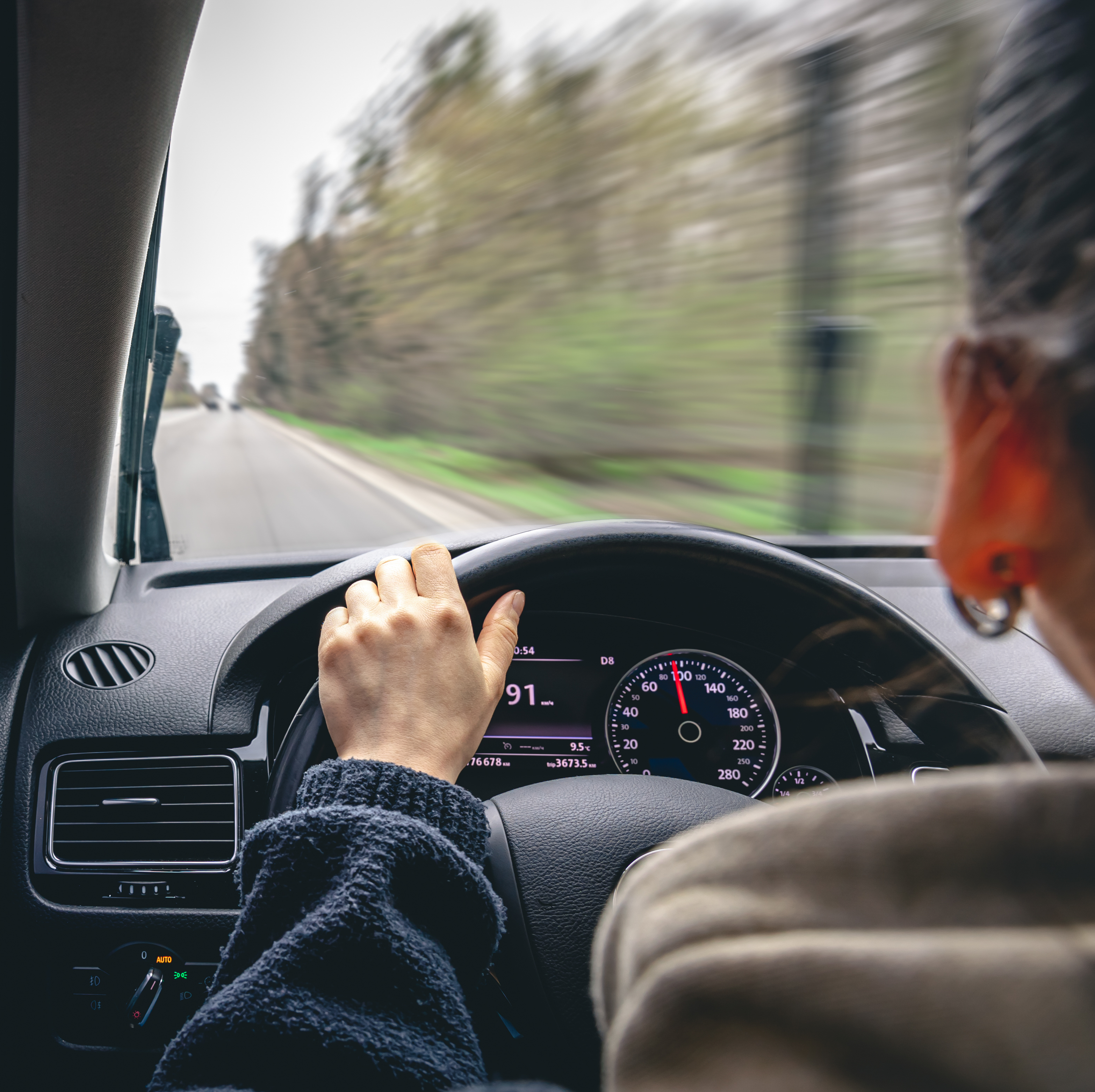 A woman driving her car.