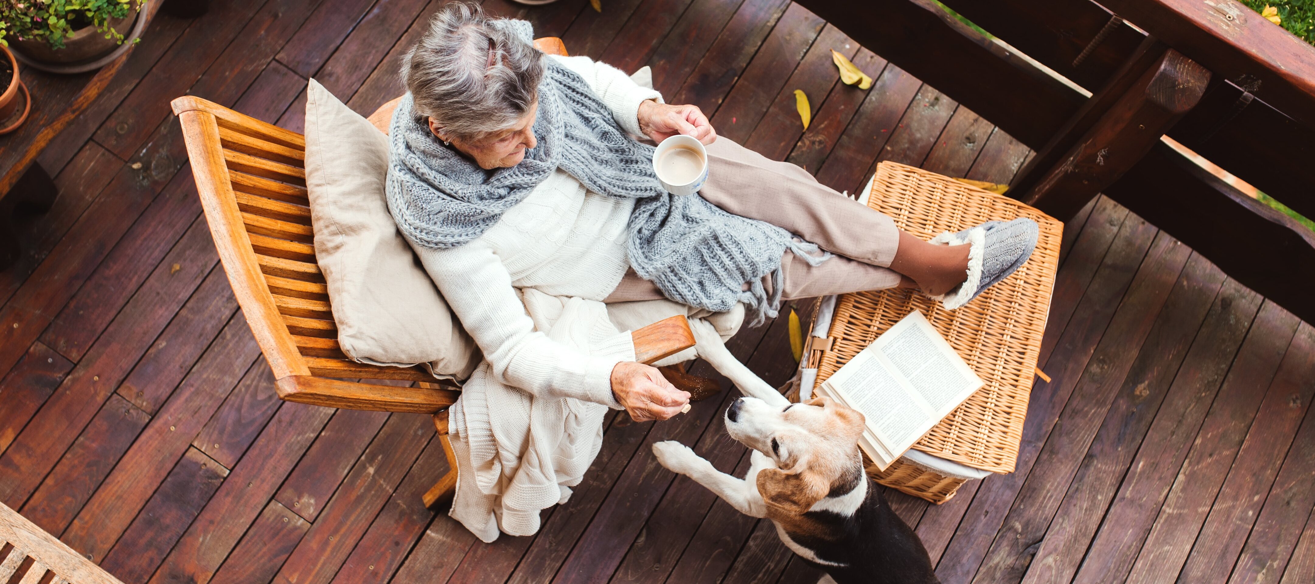 Retired woman on porch with her dog.
