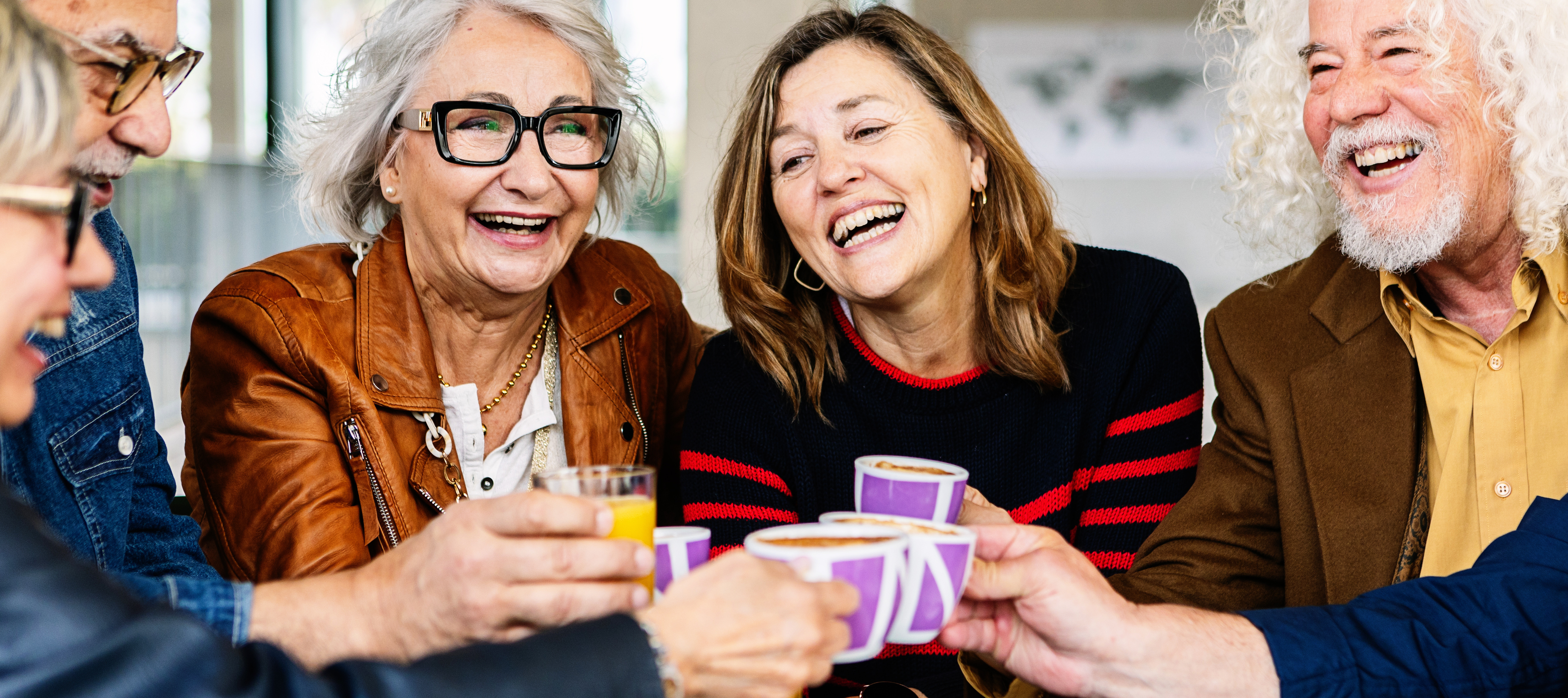 A group of older Americans enjoy their coffees together.