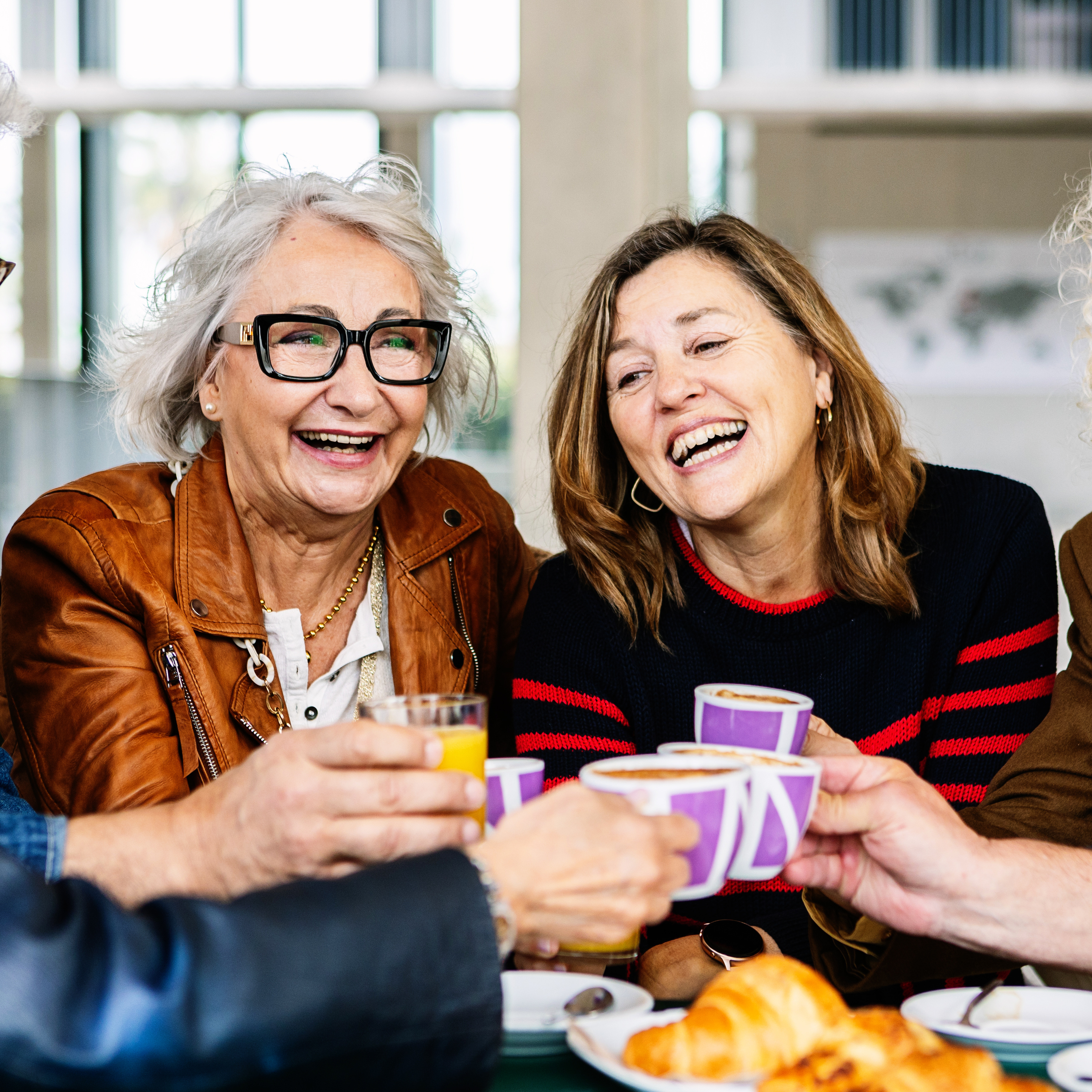 A group of older Americans enjoy their coffees together.