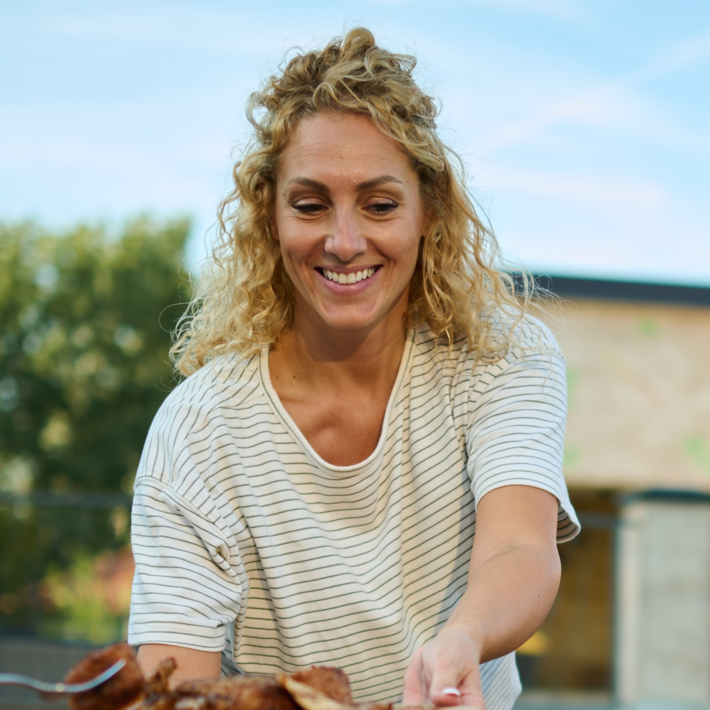 A multigenerational family enjoys lunch together in their backyard.