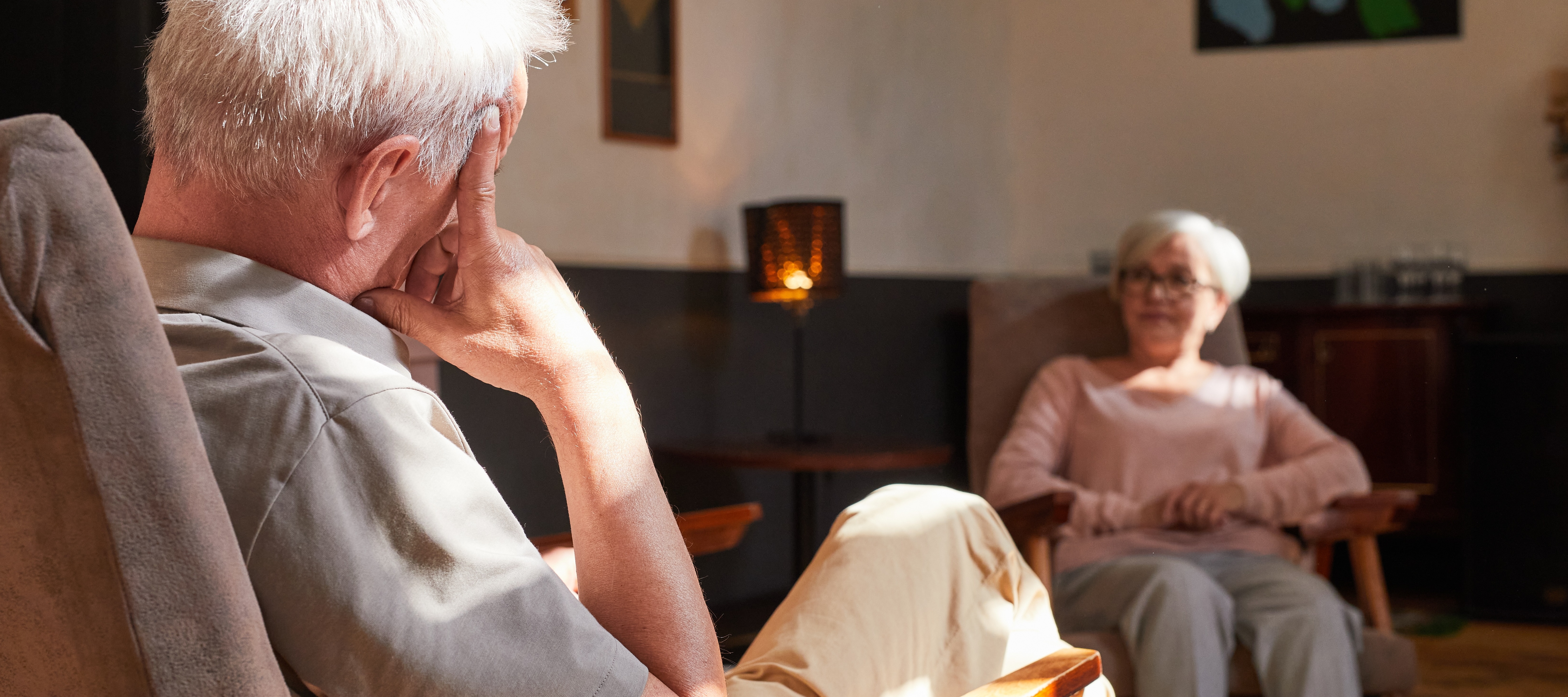 An older couple sitting in front of a fireplace could see impacts on their energy bills as a result of the war in Iran.