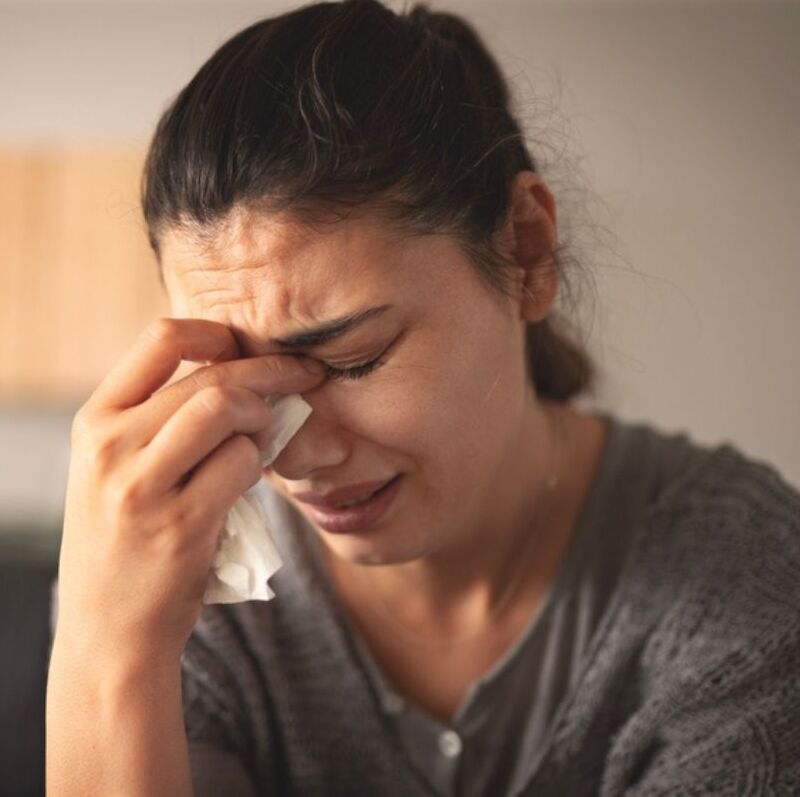 Image of trading cards and a woman crying